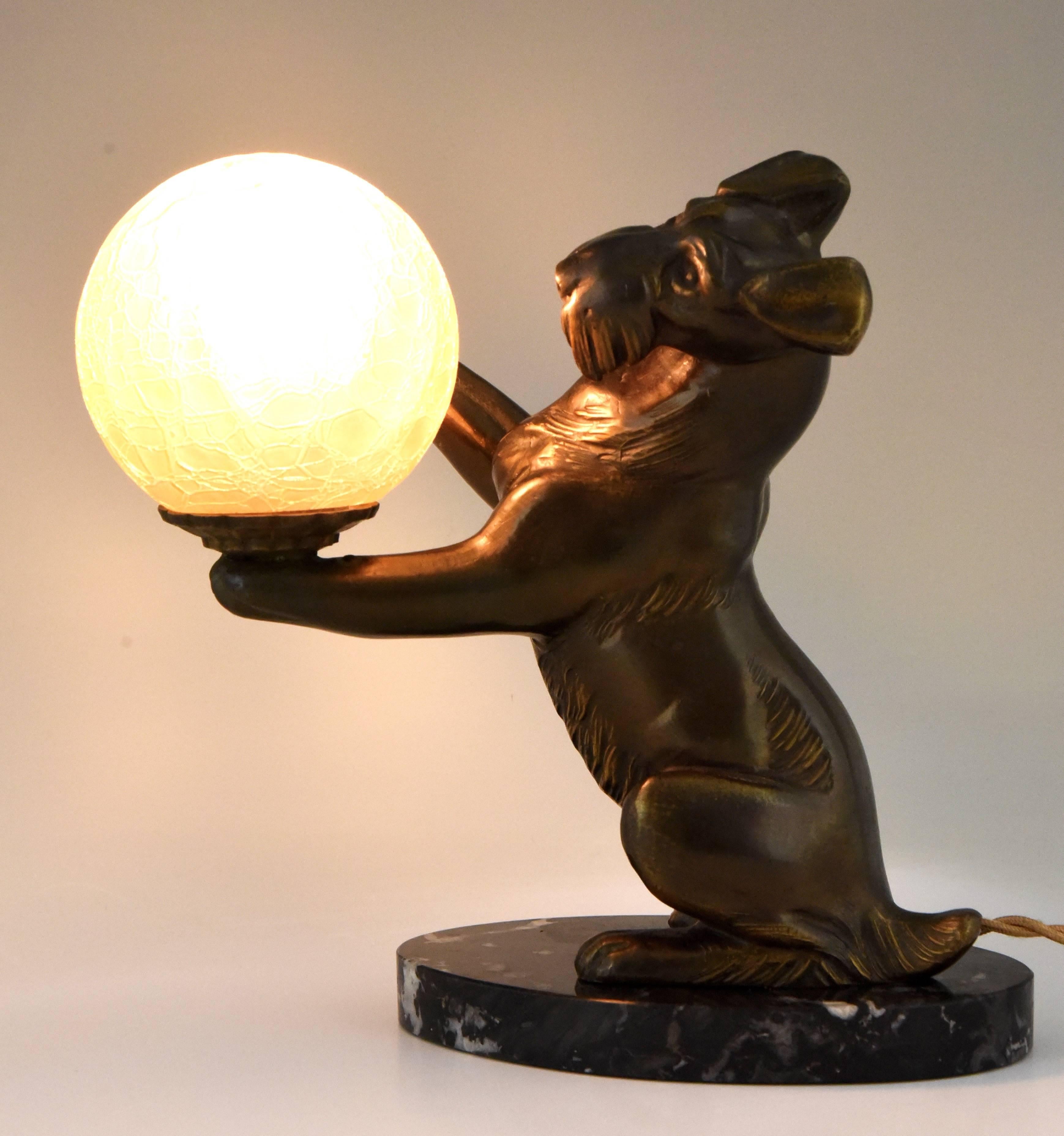 Description: Art Deco lamp with fox terrier dog holding a crackle glass globe.
Artist / Maker: Irenée Rochard.
Signature / Marks: Rochard.
Style: Art Deco.
Date: 1930.
Material: Patinated Art metal? Crackle glass globe.? Marble base.
Origin: