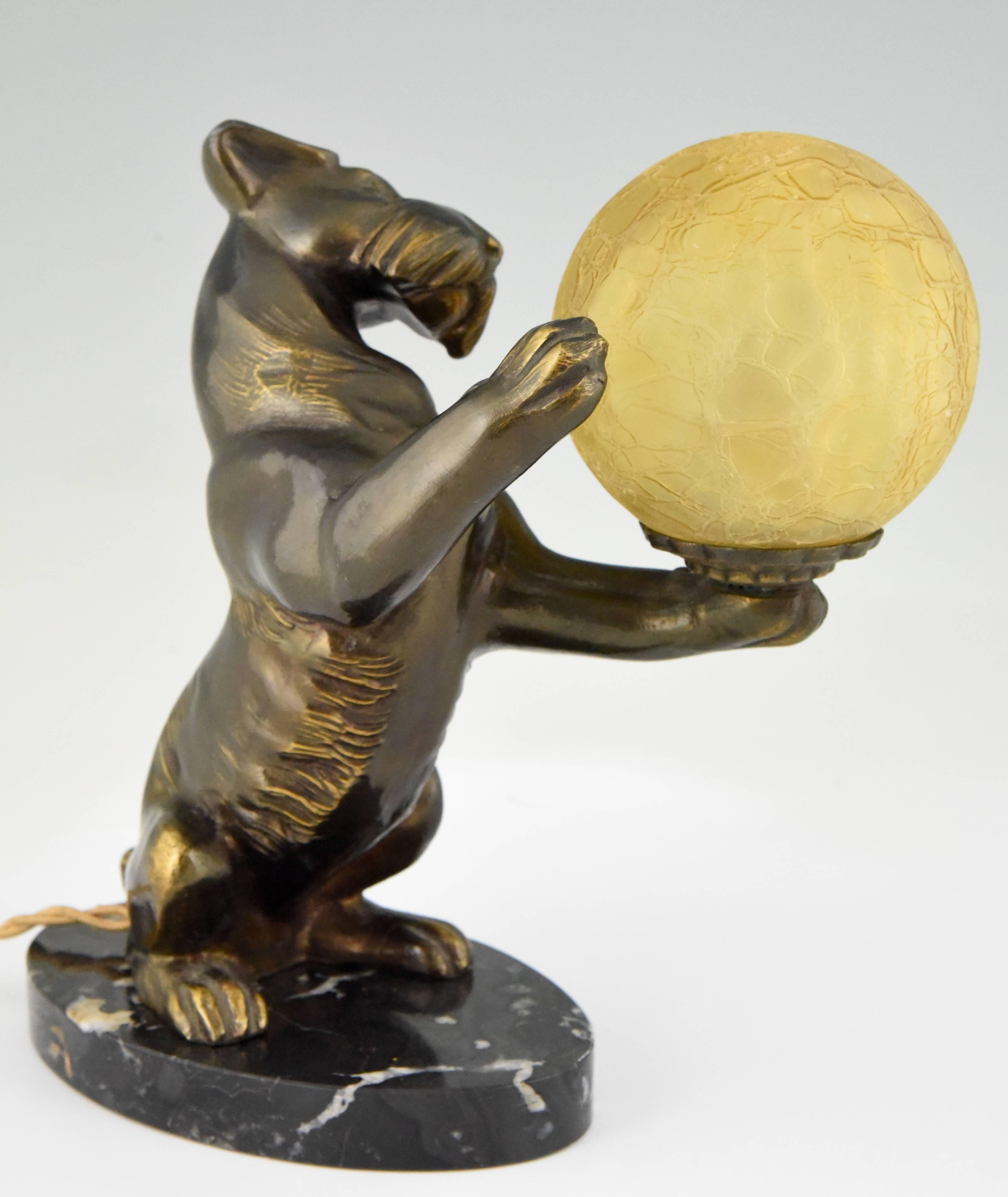 Patinated Art Deco Lamp with Fox Terrier Dog Holding a Glass Globe by Rochard, France 1930