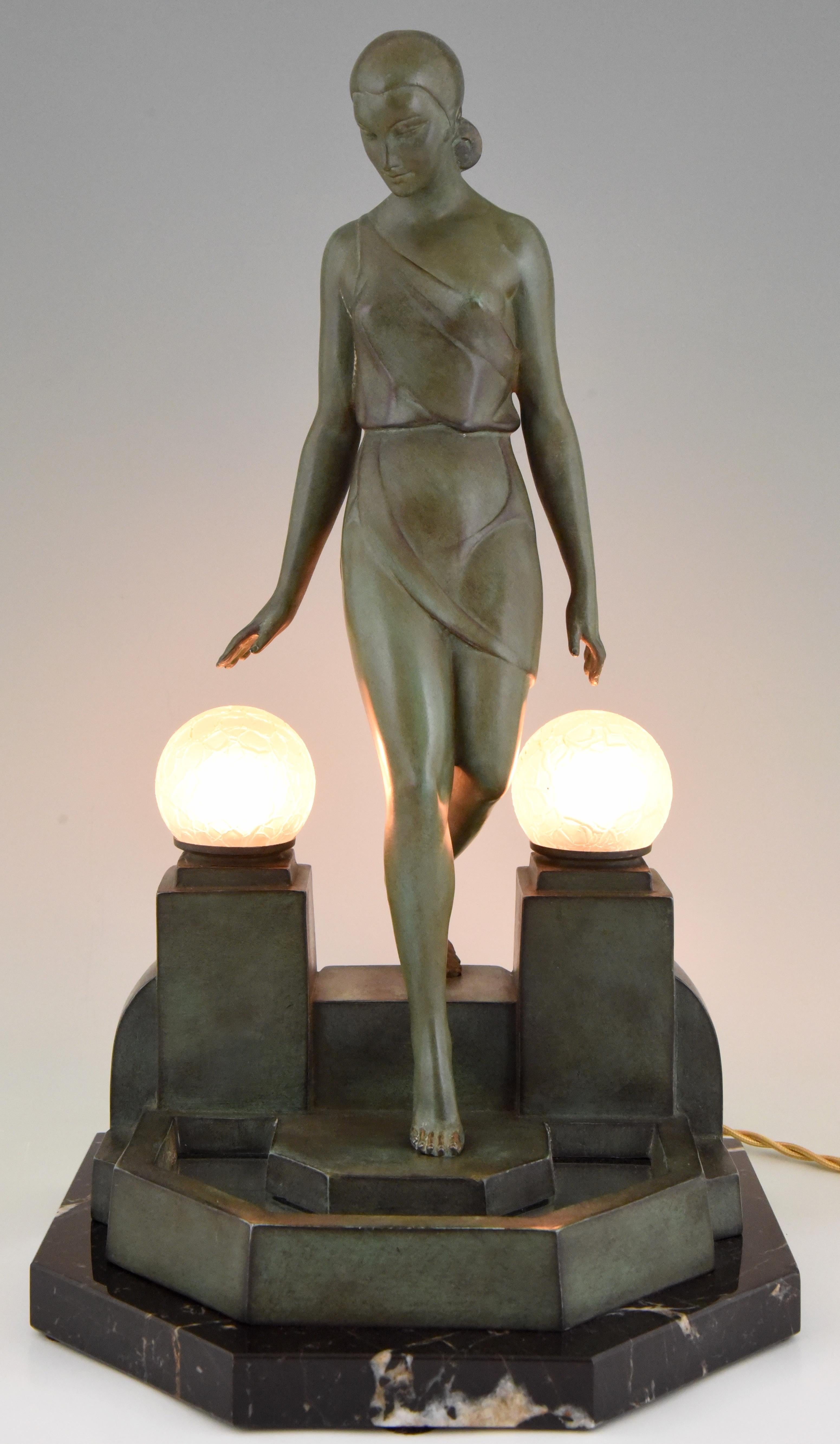 Stylish Art Deco sculptural table lamp by Pierre Le Faguays,
titled Nausicaa.
The lamp is a picturing a woman walking down a fountain, 
The sculpture is signed Fayral for Pierre Le Faguays and was cast by the Le Verrier foundry. The sculpture is