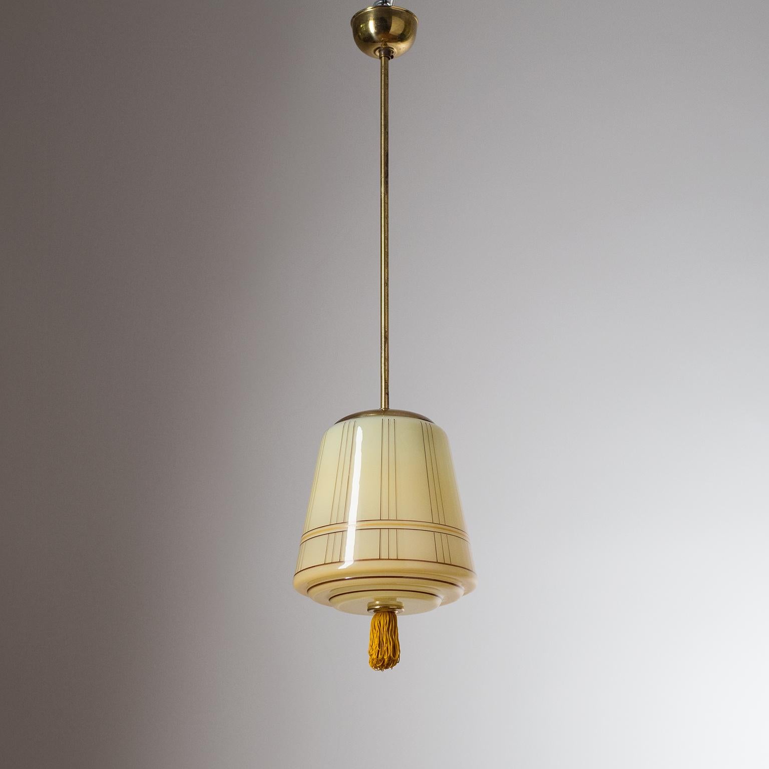 Very fine German Art Deco pendant/lantern, circa 1930. The elegant blown glass diffuser is enameled on the inside with a dark ivory color and has hand painted stripes on the outside as well as a finial tassel. Good condition with some patina on the