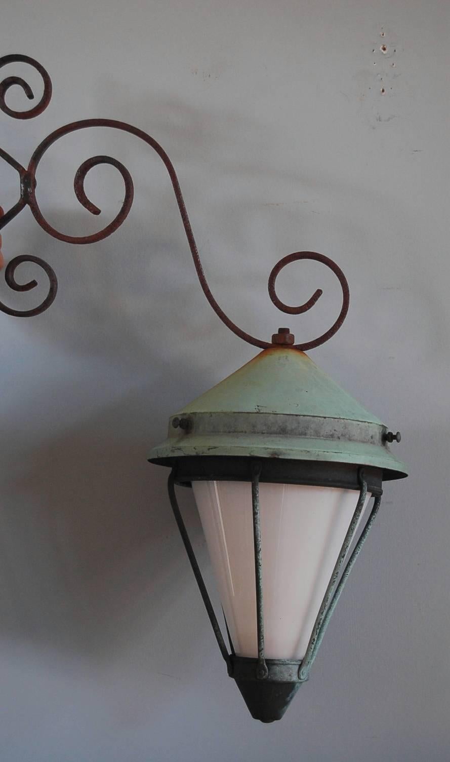 Swedish Art Deco lantern with original bracket, origin Sweden, circa 1920, copper, iron and milk glass.

Full dimensions including bracket: 59 x 36 x 25 cm 
Lantern only: 29.5 x 25 x 25 cm 