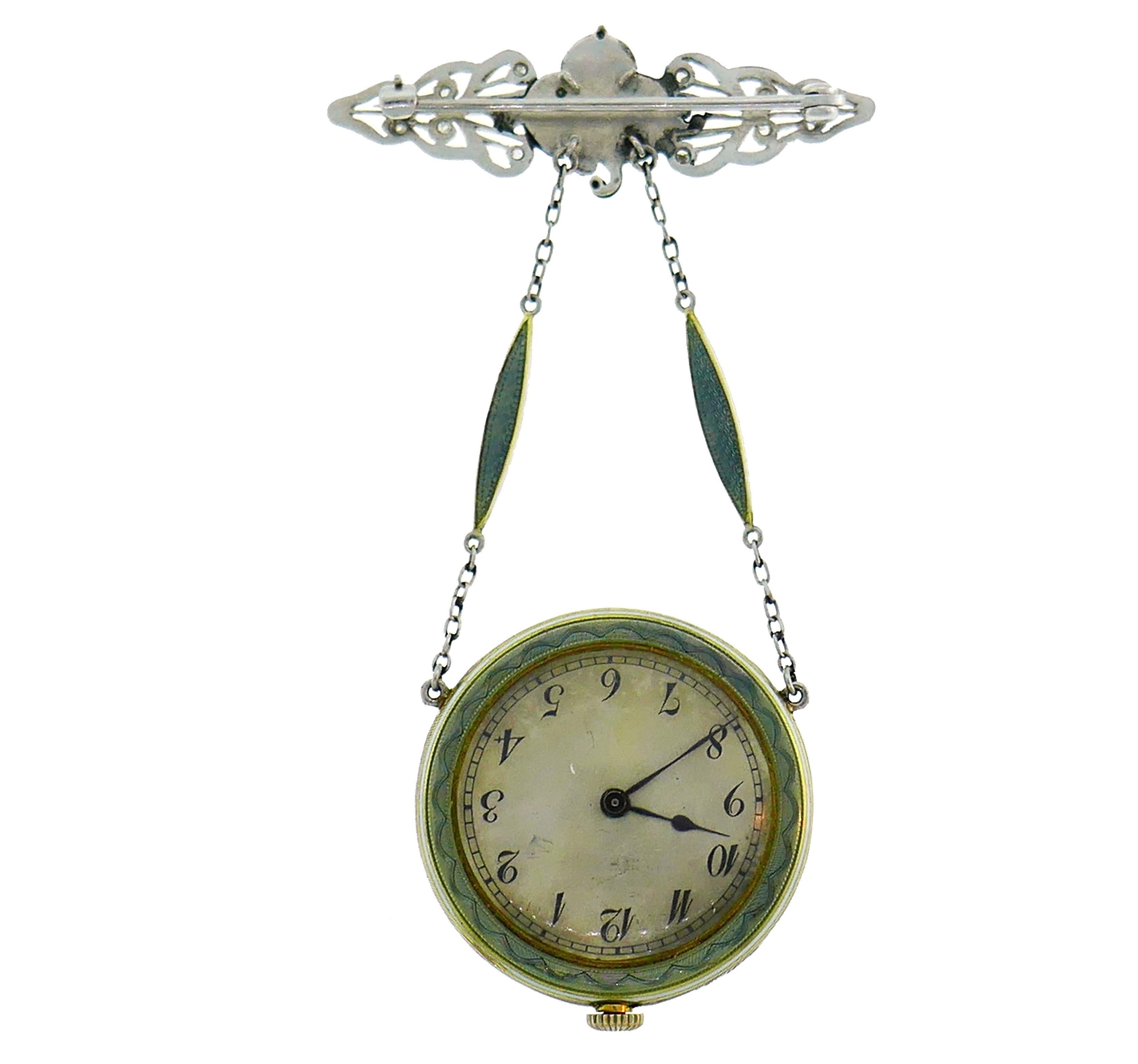 Lovely Art Deco lapel watch pendant created in the 1920s.
The watch is made of platinum, yellow gold, enamel and set with rose cut diamonds. The pin part is made of 14 karat white gold.
Measurements: 2-1/2 x 1-1/2 inches (6.5 x 4 centimeters); watch