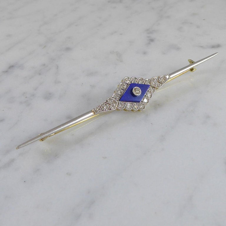 Elegant Art Deco brooch set with lapis lazuli and diamonds.  To the centre a diamond shaped, slab cut lapis lazuli with chamfered edges and set to the centre with an old cut diamond to a border of 24 further old cut diamonds. The lapIs lazuli and