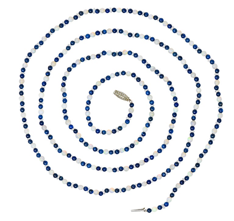 Long strand necklace is comprised of round jelly opal and lapis lazuli beads

Alternating in a pattern with faceted rock crystal quartz rondelles - transparent and eye clean

Opals are 4.5 mm, translucent, with varying strengths of