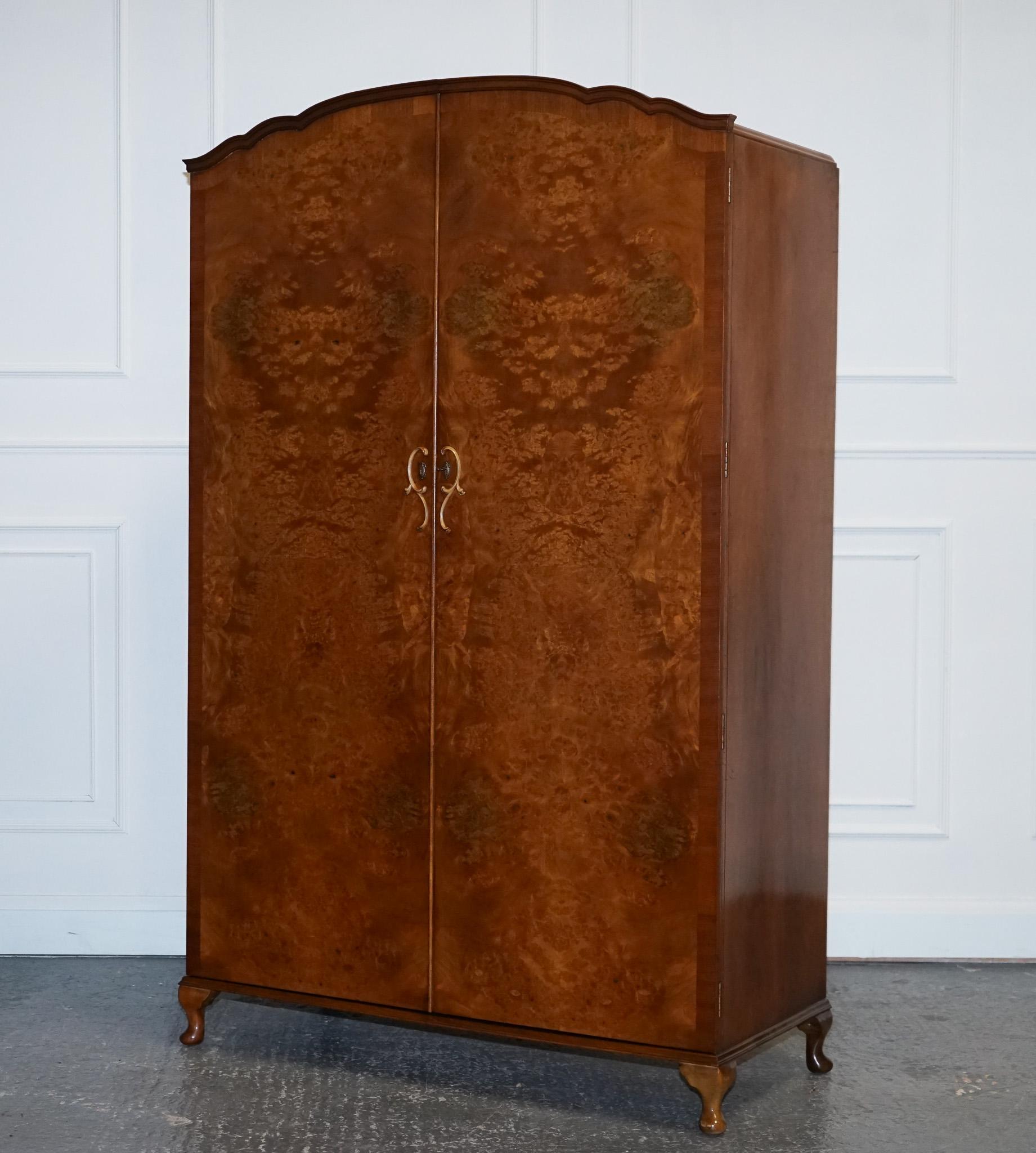 
We are delighted to offer for sale this Beautiful Art Deco 1940s Burr Walnut Wardrobe With Queen Anne Feet Style.

A 1940s Art Deco Burr Walnut Wardrobe with Queen Anne feet is a stunning piece of furniture that embodies the elegance and