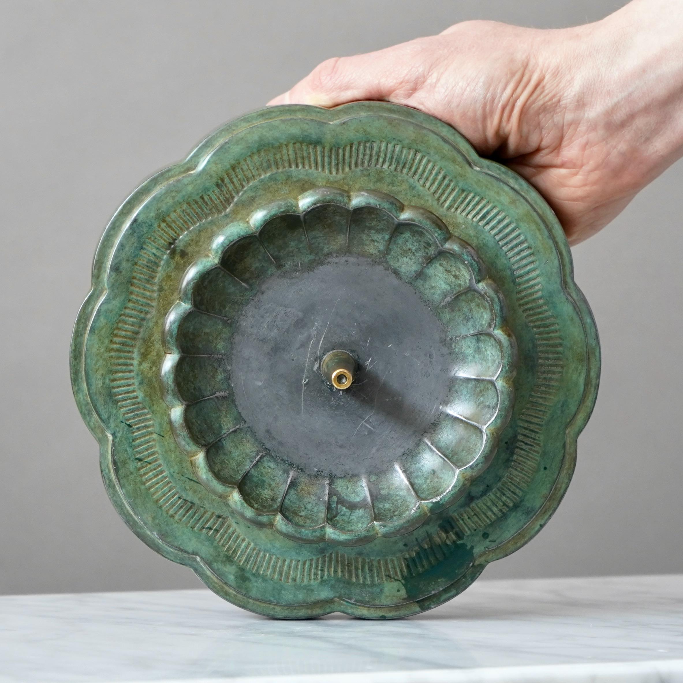 A beautiful art deco candle holder for large candles. Designed by Just Andersen in 1930s and produced by his own company in Denmark. Made from Disko metal (an alloy of different metals invented by Just Andersen).

Good condition. But with some