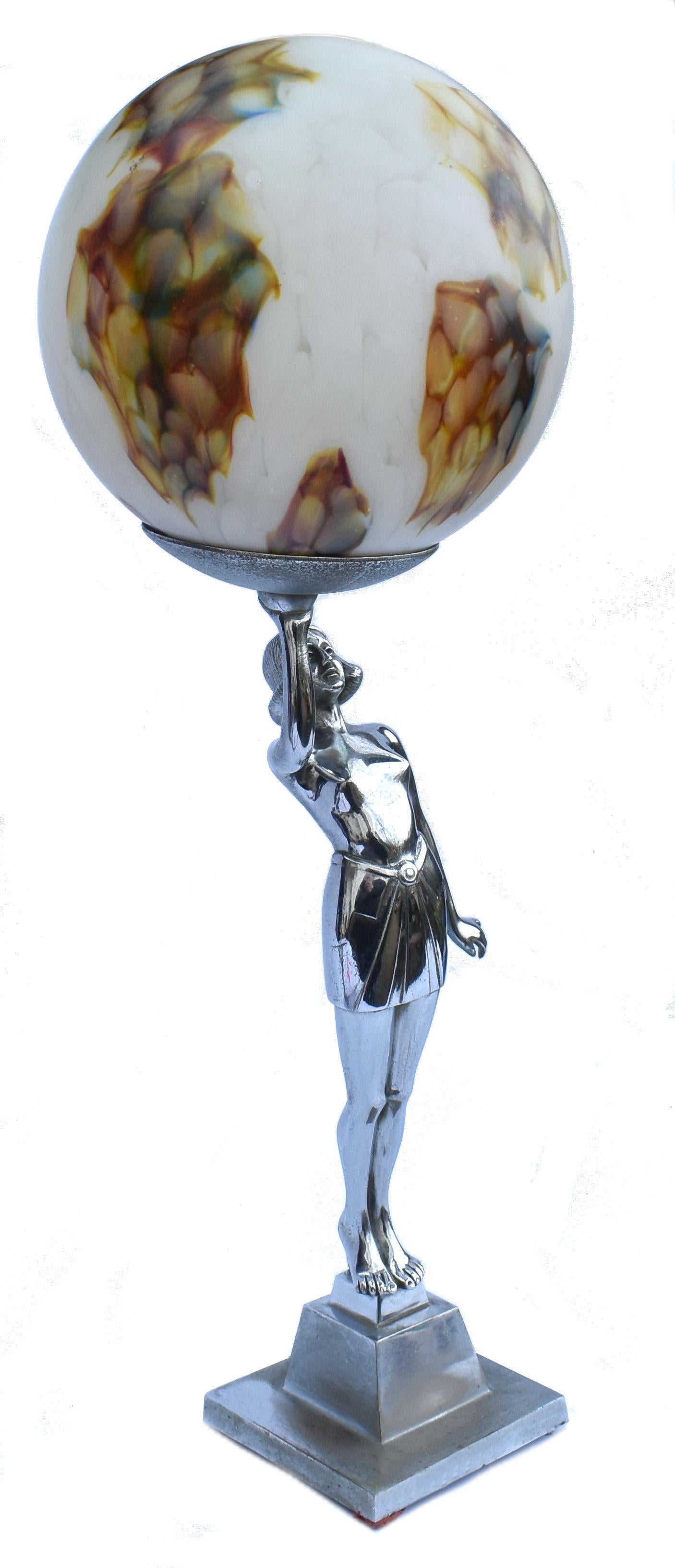 An impressive 50 cm tall this original 1930's Art Deco chrome table lamp and features a semi nude lady holding aloft a marble effect large glass globe. She is in beautiful condition with hardly any visible wear to the chrome of her body, there is