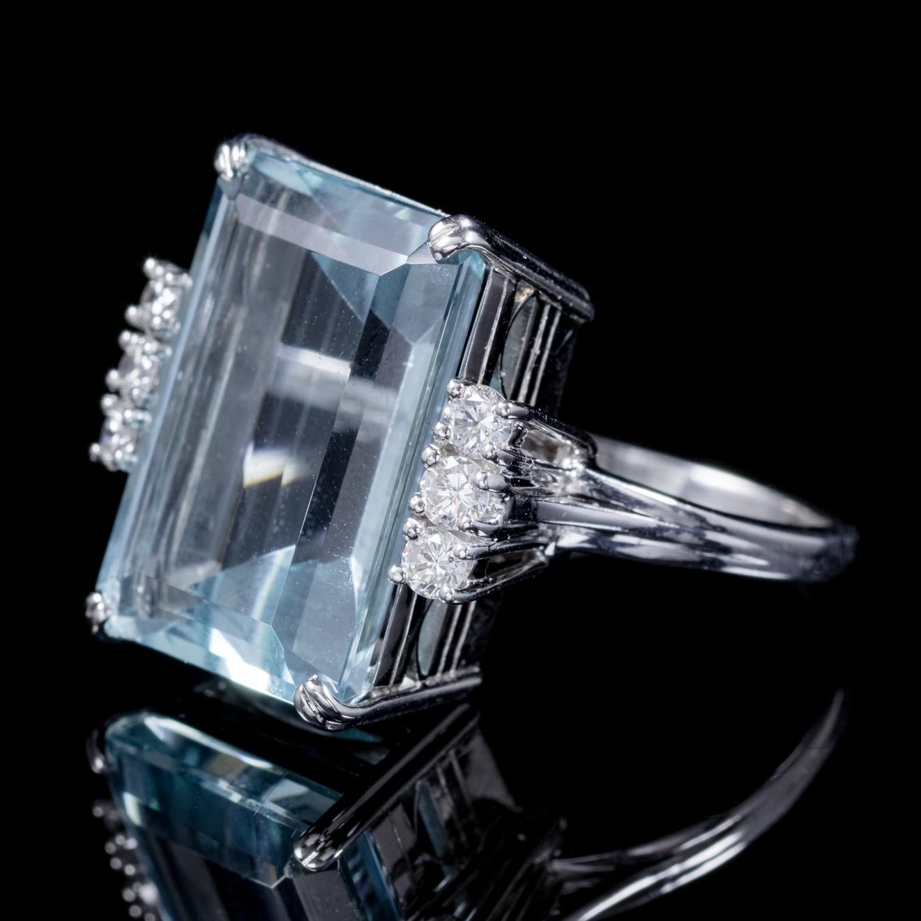 A magnificent 1920s Art Deco ring boasting a stunning 13.86ct emerald cut Aquamarine flanked by six brilliant cut Diamonds. 

Aquamarine is adored for its beautiful clear Ocean blue colour which complements most skin types. The stone was once