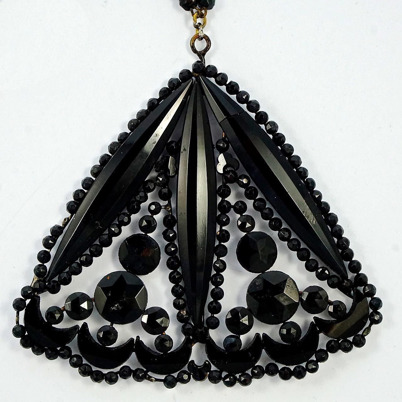 Art Deco large hand cut french jet pendant with a beaded chain necklace, and barrel clasp. The beautiful pendant has crescent, round and marquise shaped faceted french jet pieces. Each piece is in a black enameled setting and applied to enameled