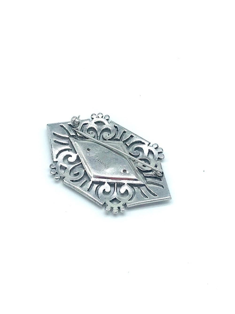 Art Deco, Lg. marcasite Sterling Pin Measuring 2.5 x 1.5 is a lovely pin with open workmanship . The center is a layered black oxidized opening upon bezel of marcasite  stones
Substantial, 16.1 grams of sterling silver. Attached is a 2 inch pin with