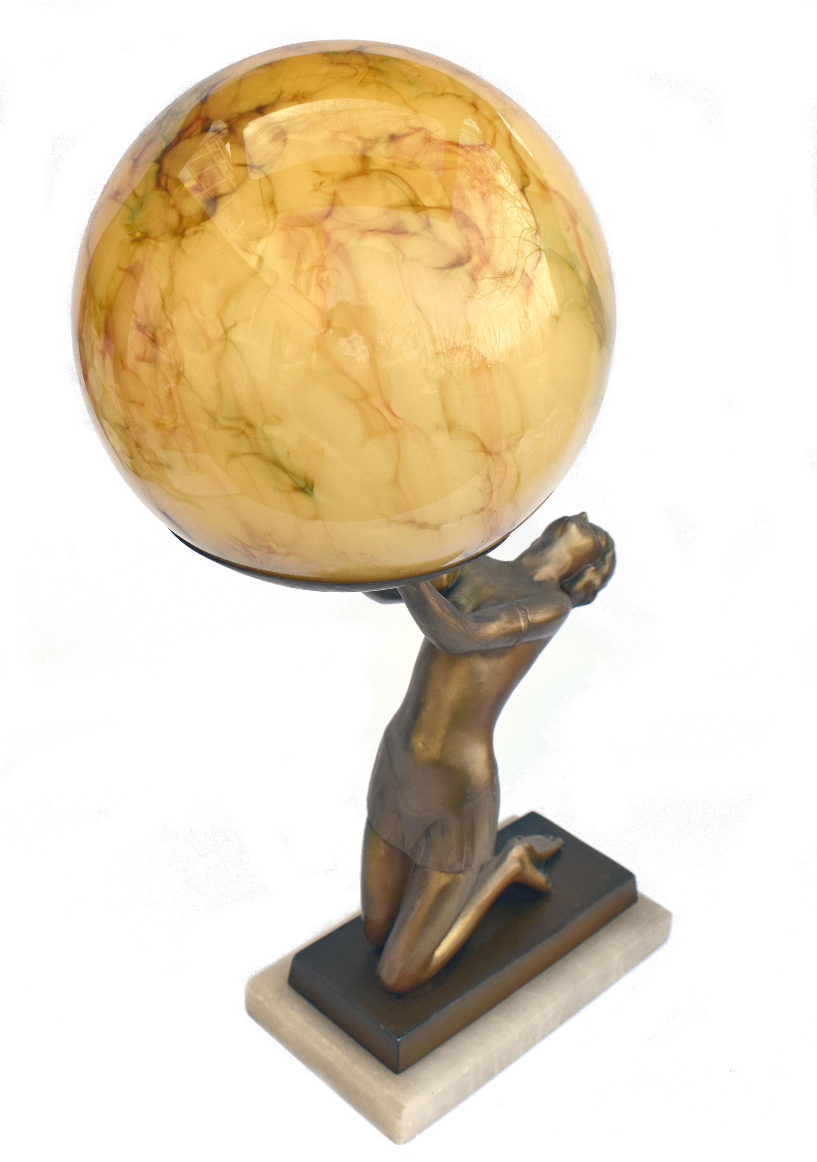 An impressive 38 cm tall this original 1930's Art Deco cold painted spelter table lamp features a nude female holding aloft a sepia marble effect glass globe shade. Kneeling on an alabaster & spelter base she is in beautiful condition with very
