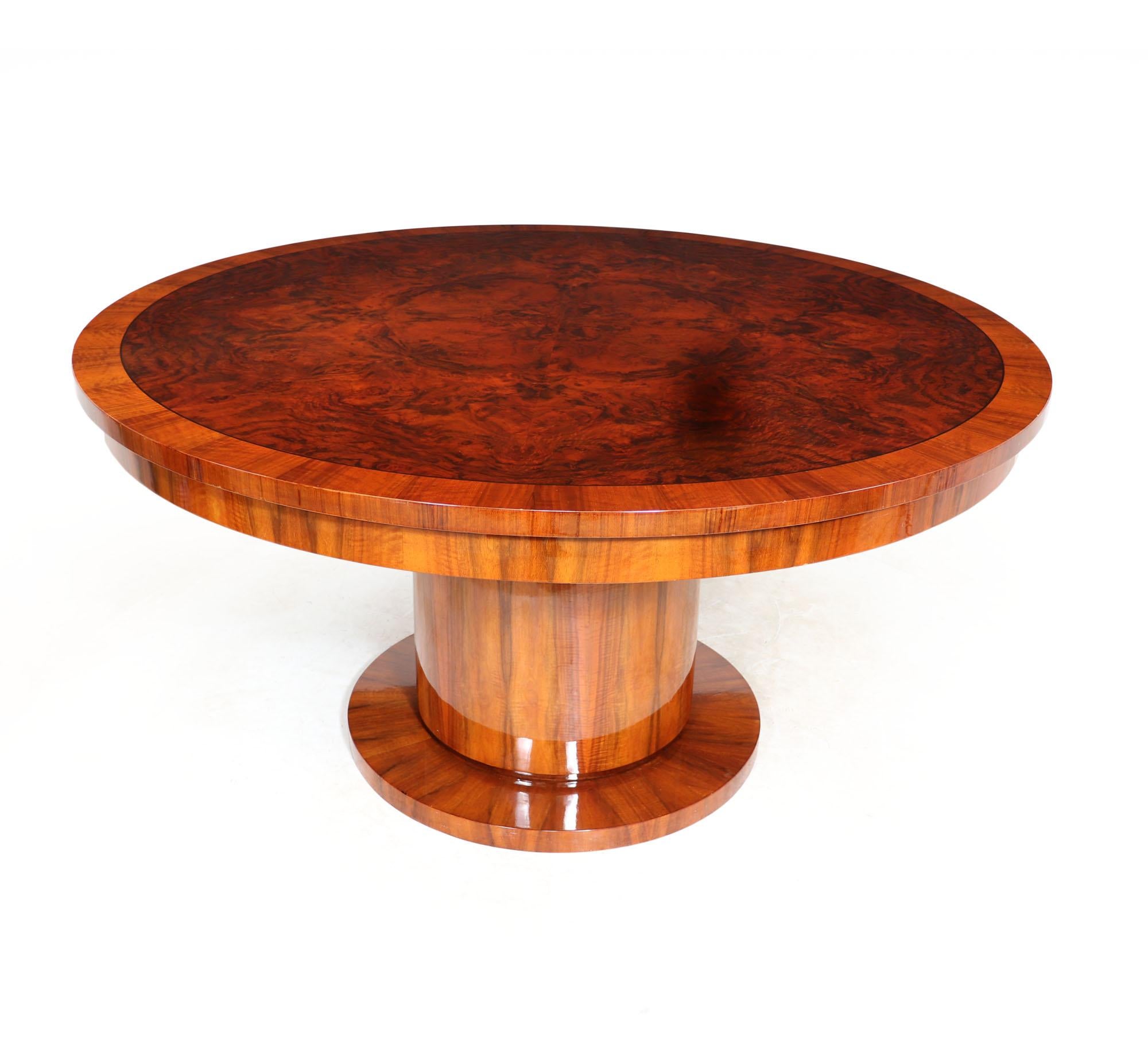 ART DECO ROUND DINING TABLE 
A large Art Deco dining table produced in burr walnut and figured walnut, having a circular top that could seat up to 8 people and standing on a central column pedestal base the table is in very good condition from its