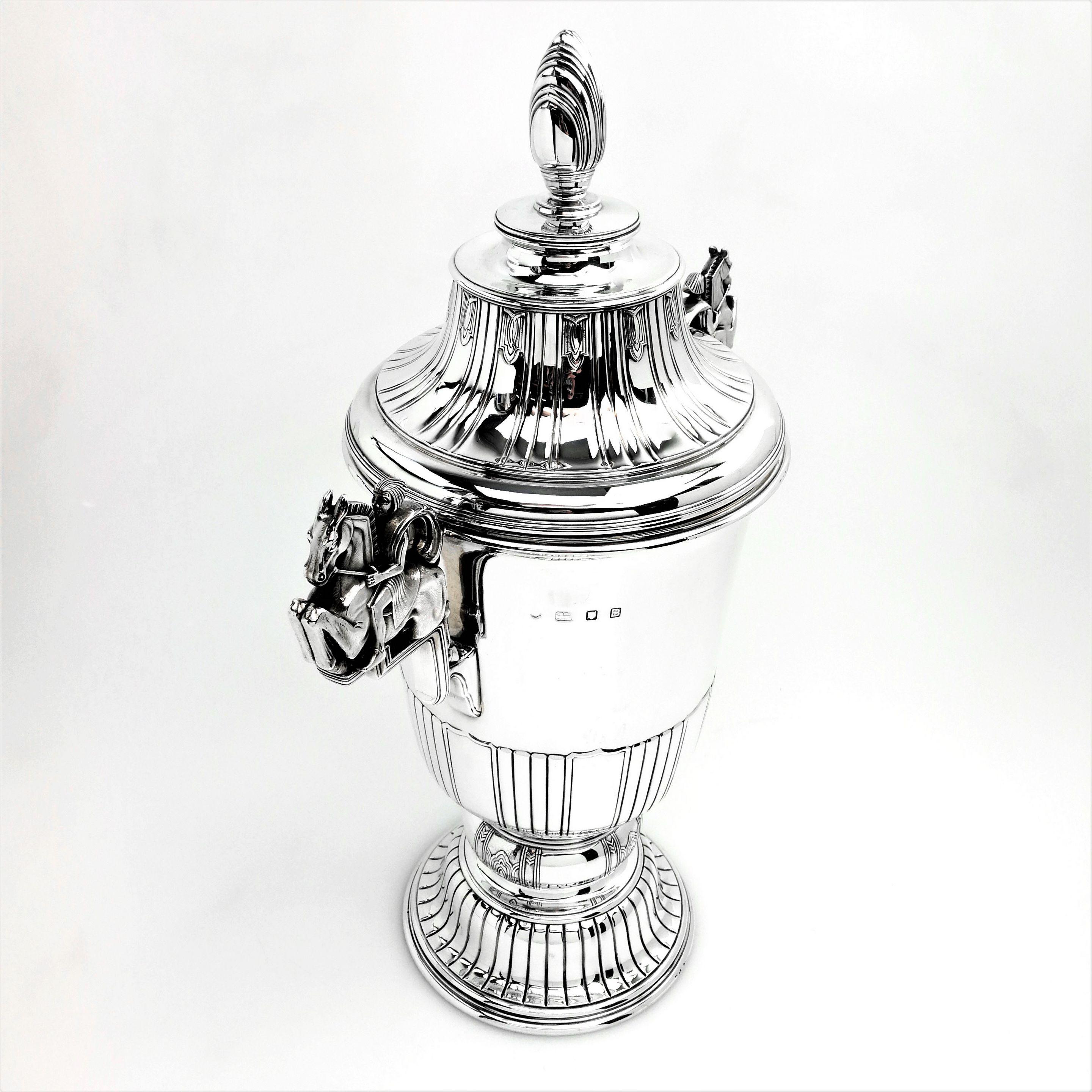 A magnificent solid silver Art Deco Cup & Cover / trophy. This impressive piece exemplifies the strong design elements typical of the Art Deco period, and is of notably substantial size and weight. The tall Cup stands on a spread pedestal foot and