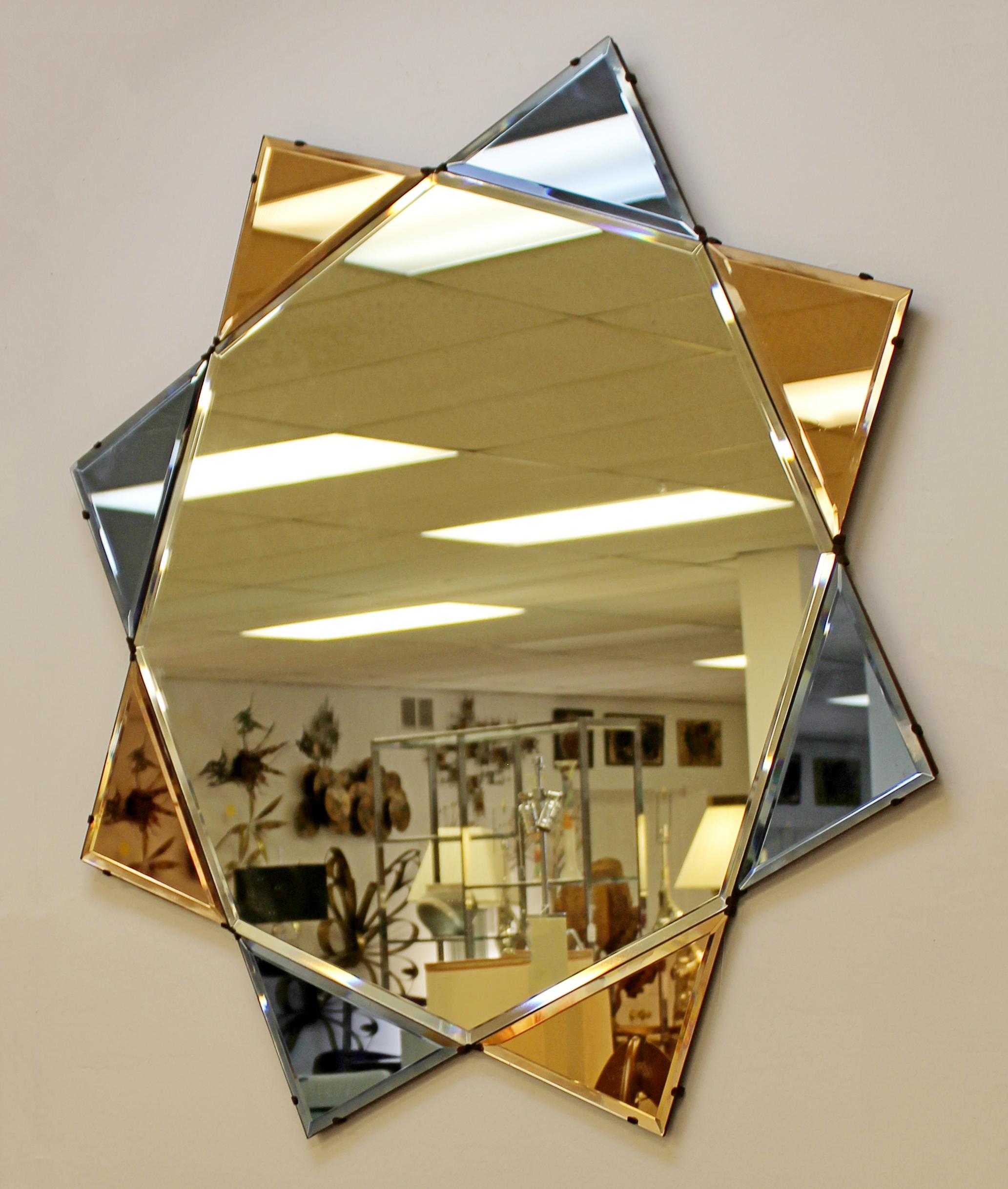 For your consideration is a captivating, large, diamond or star shaped wall mirror, with blue and pink tinted sections, despite the pink sections appearing orange in the photos; circa 1930s-1940s. In excellent antique condition. The dimensions are