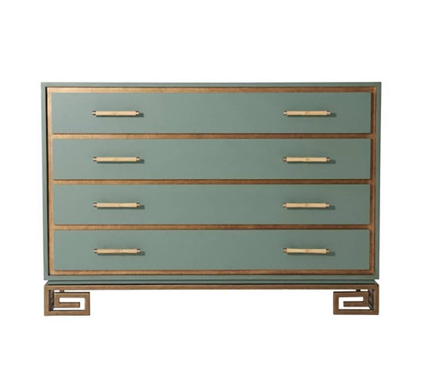 A laurel green painted and gilt chest of drawers, the rectangular top above four recessed gilt framed drawers with bamboo stem handles and brass accents, on a vintage gilt steel Greek key base.

Dimensions: 52