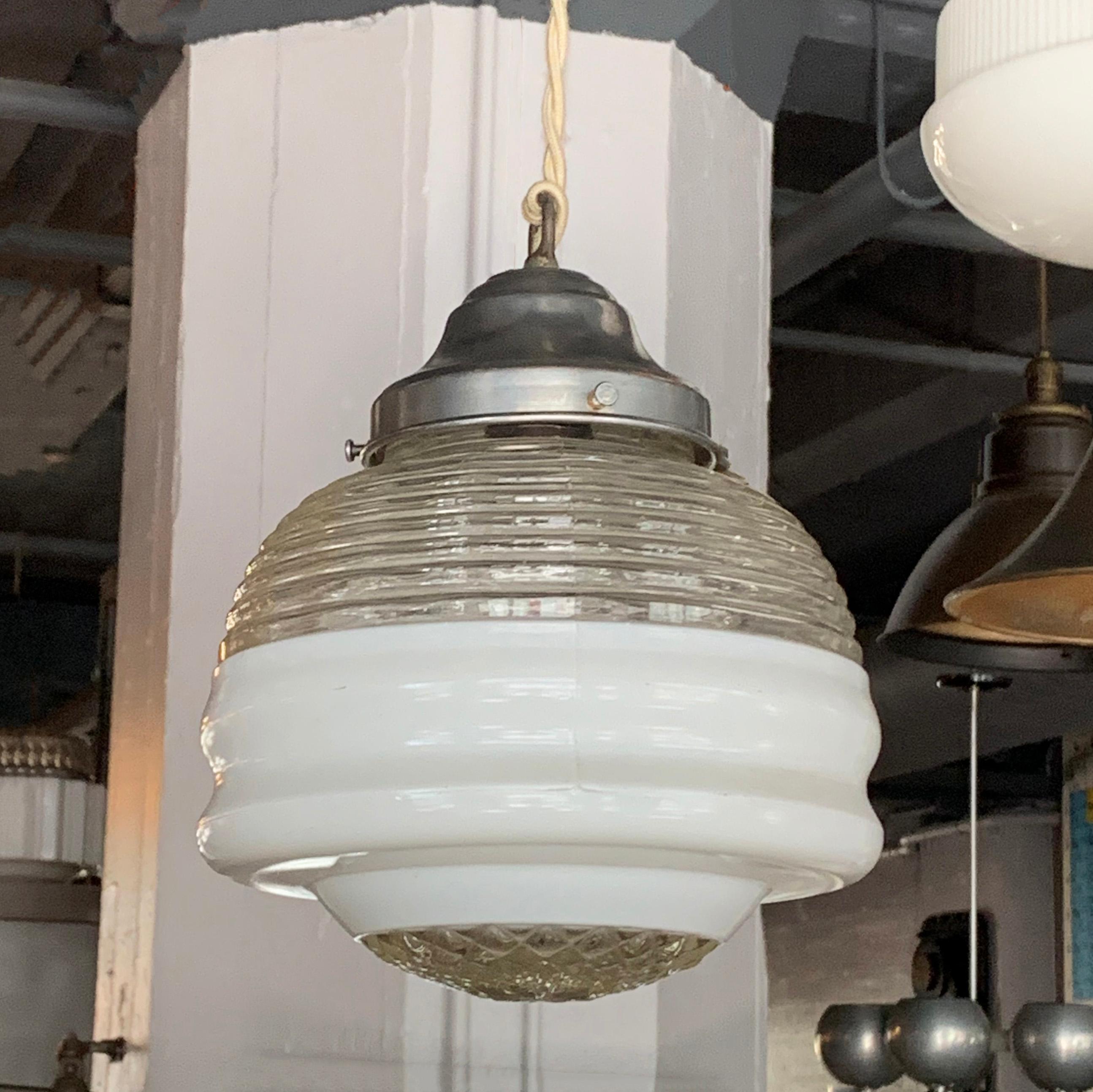 Art Deco pendant light with a layered shade of ribbed, frosted and cut glass with aluminum fitter is newly wired with 48 inches of braided beige cord to accept a 150 watt bulb.
