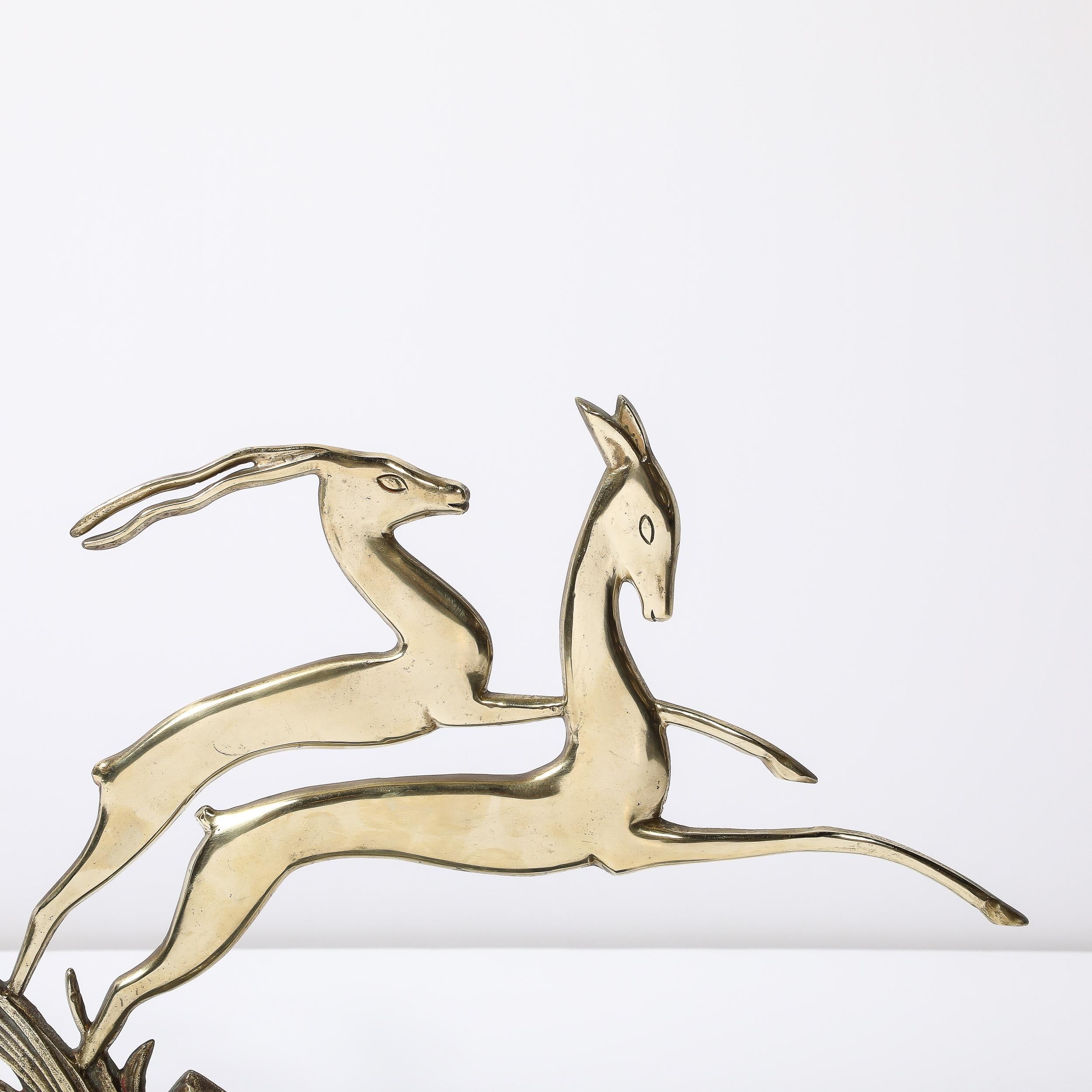 This beautifully formed and striking Art Deco Leaping Gazelle Sculpture in Polished Brass on Black Marble Base originates from France, Circa 1930. Featuring an open construction in gleaming polish brass depicting two leaping gazelles, one with