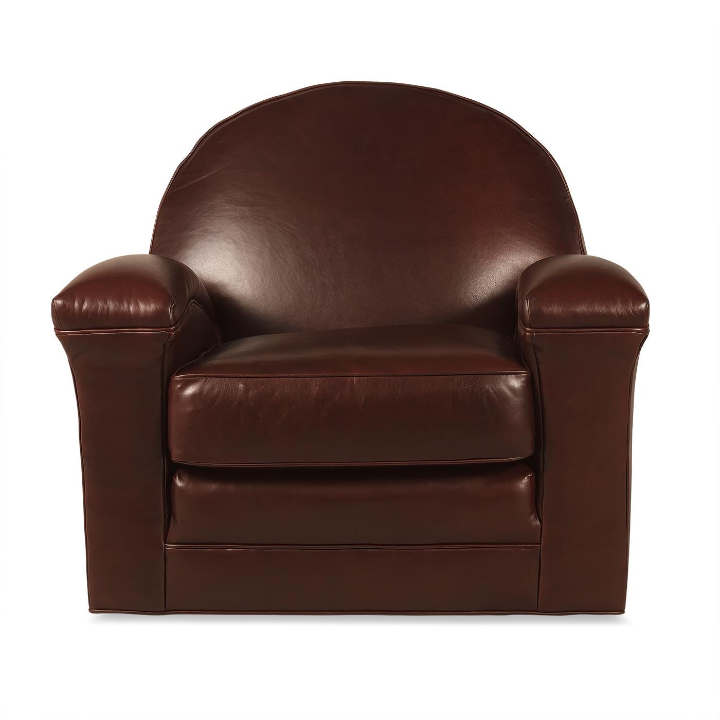 An Art Deco inspired custom leather upholstered club chair. This armchair with a bold and comfortable dome backrest, with long and low sweeping arms with a boxed cushion seat raised on a swivel base. 

Dimensions: 36