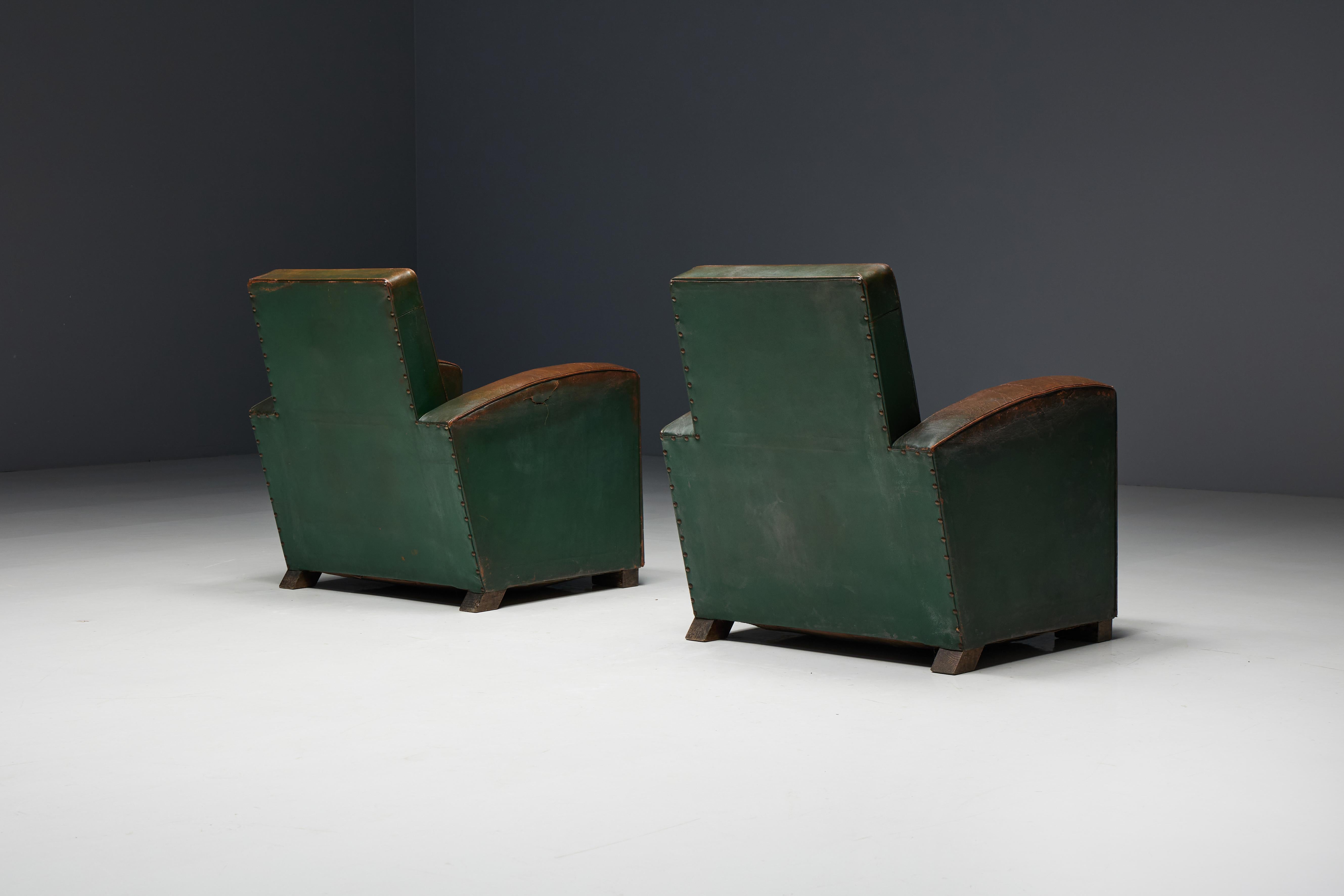 1930s Art Deco armchairs, inspired by the iconic designs of Jacques Adnet and Maison Dominique. Originating from France, these chairs showcase elegant craftsmanship with their luxurious green leather upholstery, now beautifully faded from wear. This