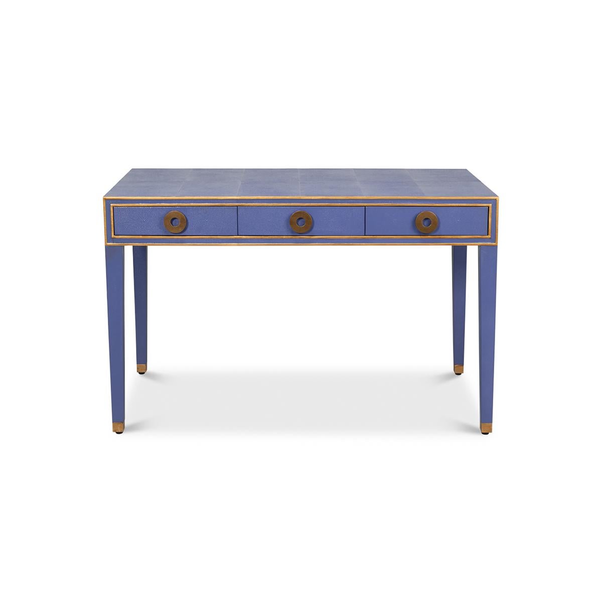 A French Art Deco style shagreen embossed leather desk in a rich cobalt marlin blue. With gilded highlight trim, three frieze drawers with modern round pulls, and raised on square tapered legs.

Dimensions: 48