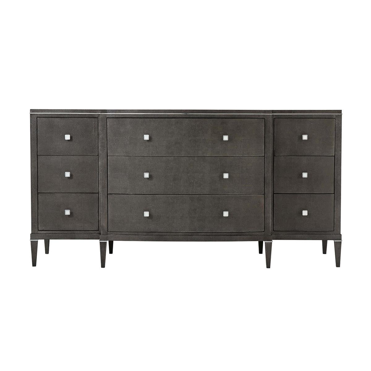 Art Deco leather dresser wrapped in shagreen embossed leather in our dark tempest finish. A nine-drawer dresser with a shaped breakfront having polished nickel hardware and details and raised on square tapered legs.

Dimensions: 71
