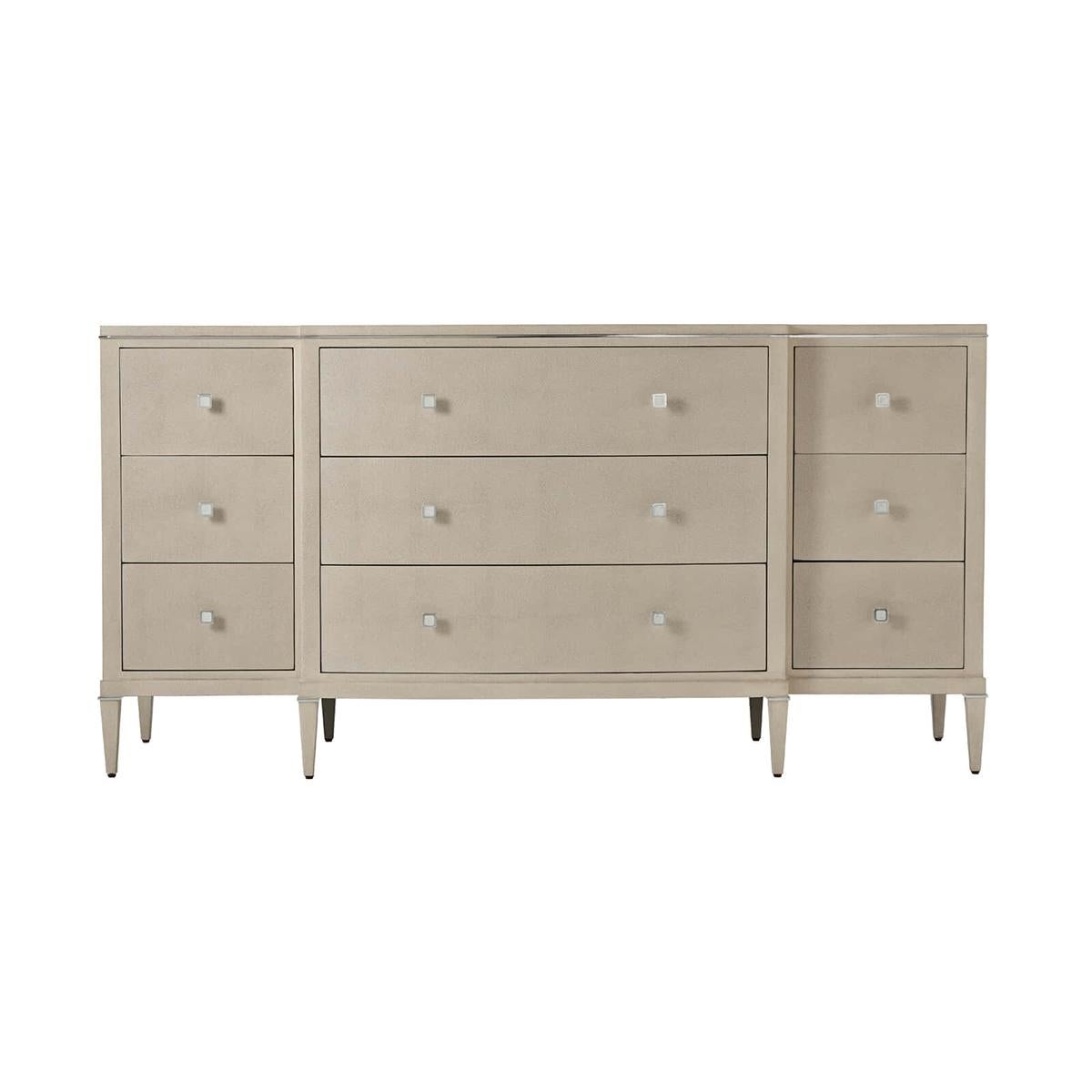 Art Deco Leather dresser wrapped in shagreen embossed leather in our light overcast finish. A nine-drawer dresser with a shaped breakfront having polished nickel hardware and details and raised on square tapered legs.

Dimensions: 71