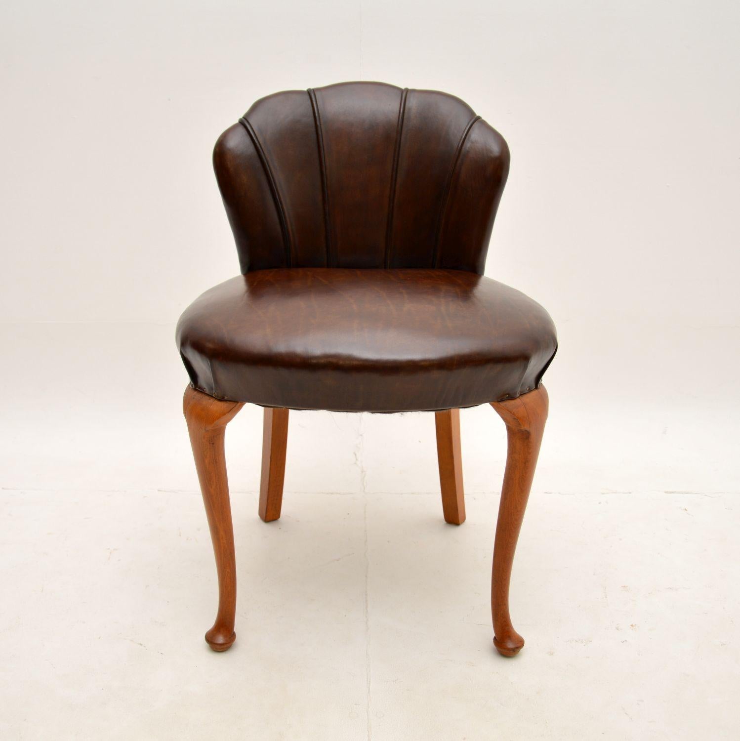 A beautiful Art Deco leather scallop back stool, made in England and dating from the 1920-30’s.

This is of superb quality, it is sturdy, well sprung in the seat, it is very comfortable and supportive. It is a perfect size to be used for a dressing