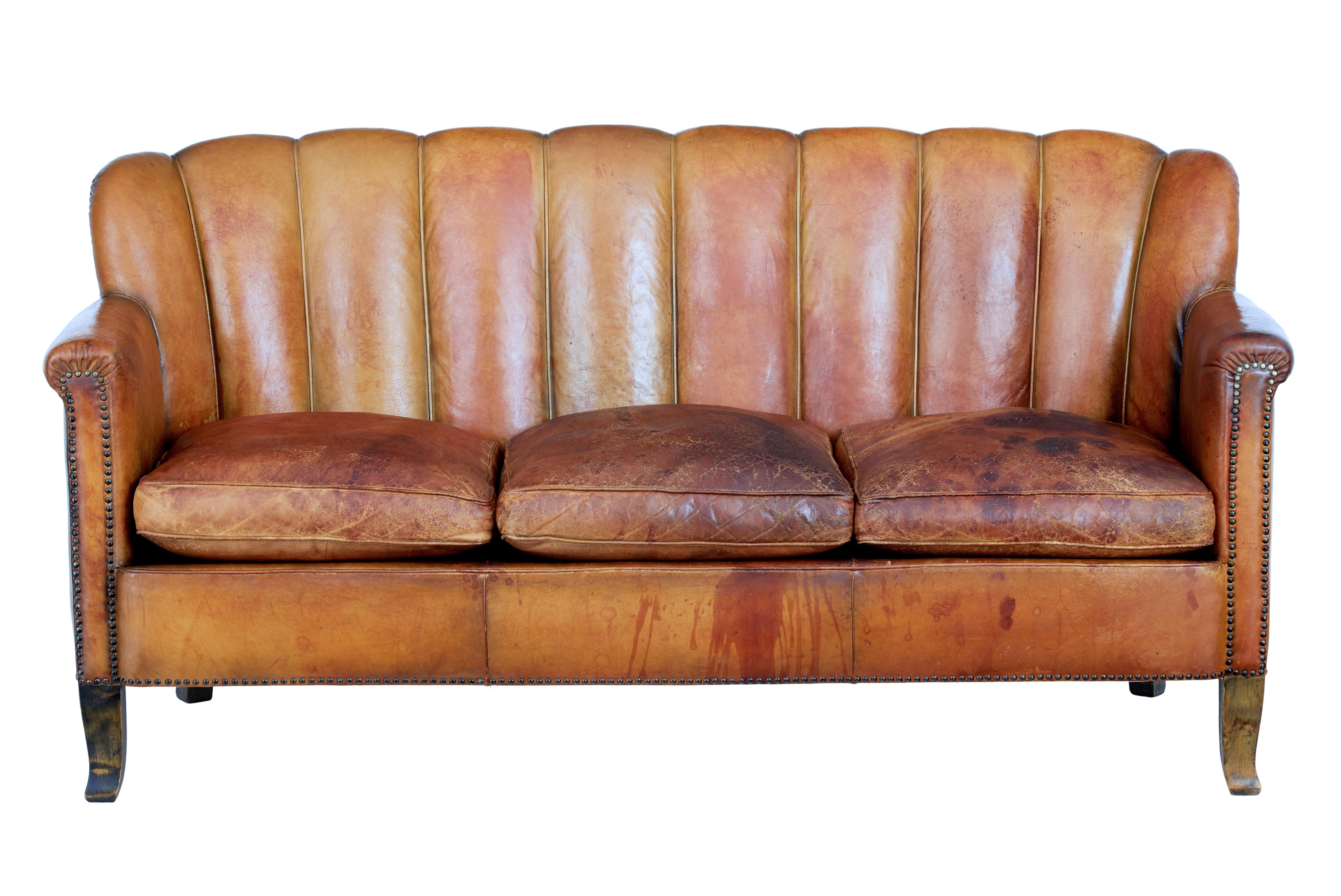 Fine quality Art Deco period 3-piece suite, circa 1920.

Suite comprises of a sofa and 2 matching armchairs. 3-seat sofa with seperate seat cushions. Shell back shaped and upholstered in original thick hide leather.

Standing on stained birch