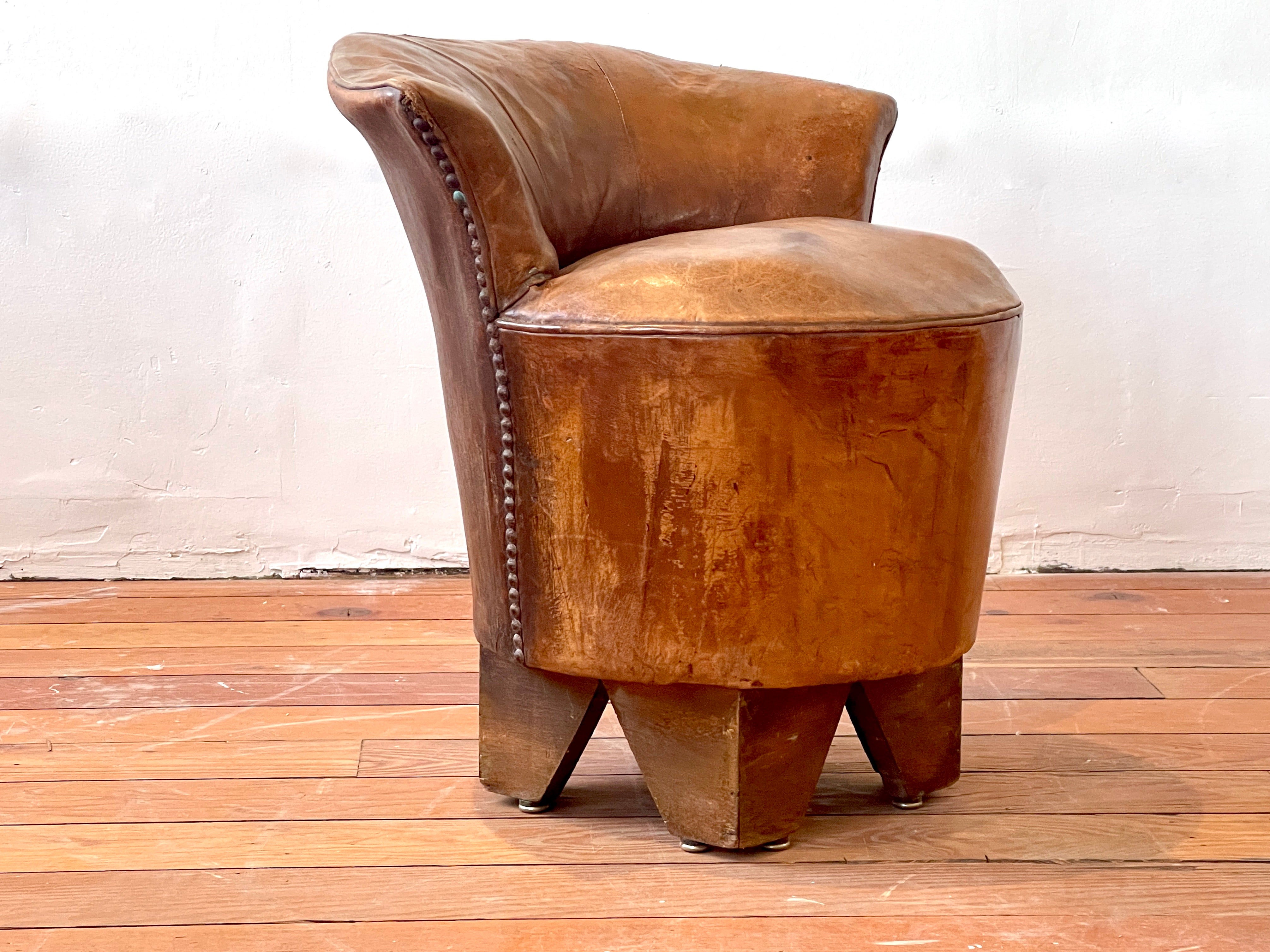 Petite Art Deco French leather stool with just the right patina and curves. 
Chunky thick legs with brass tack detail along the curved sides. 
Great shape and scale and patina. 
France, circa 1940s.