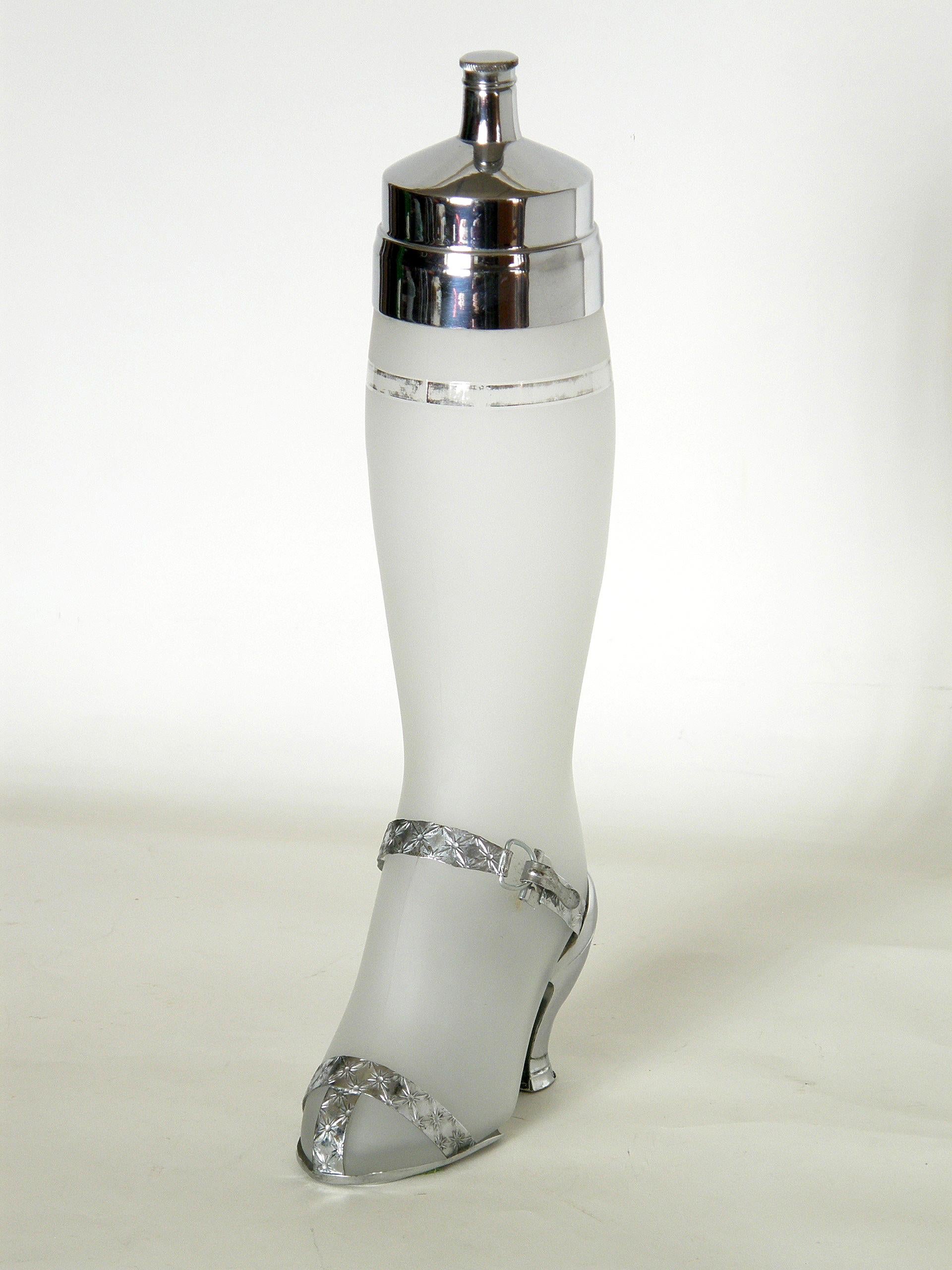 This circa 1937 figural cocktail Shaker has the form of a shapely lady’s leg in a high heeled sandal. The shoe has a functioning clasp on the strap that allows for it be removed for cleaning. The risqué design evokes the ethos of the Art Deco era
