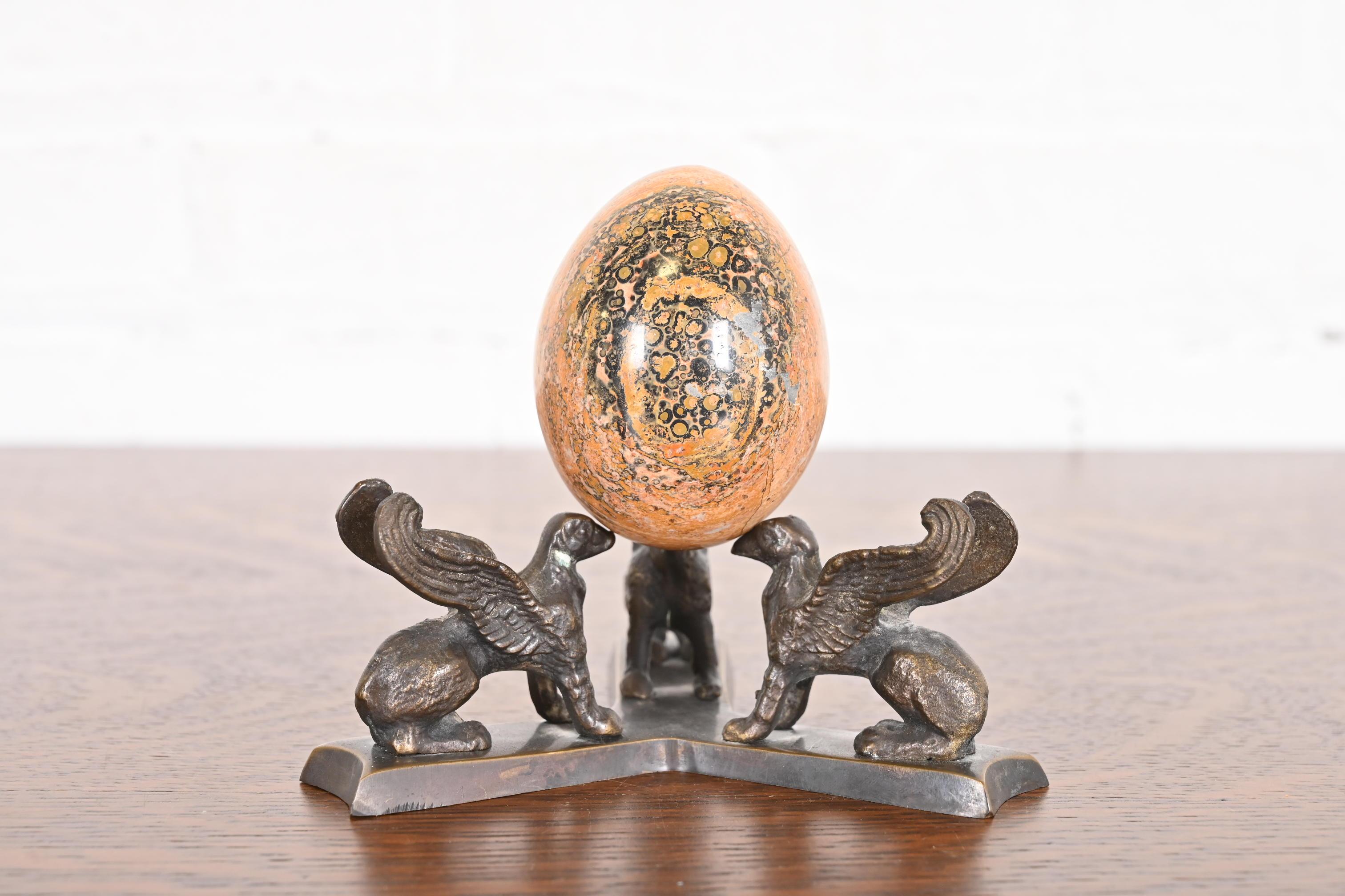 A gorgeous antique Art Deco leopard skin jasper egg on bronze base with griffins

USA, Circa 1930s

Measures: 5.5