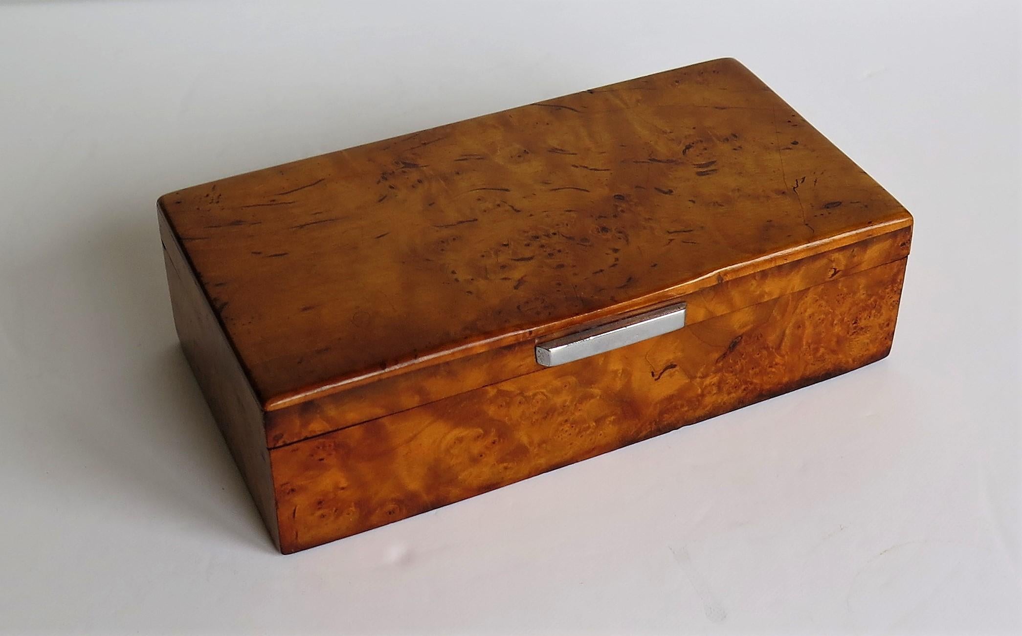 This is a very good quality French Art Deco period Lidded Box, of Bird's Eye Maple with a chrome bar handle, dating to circa 1925.
The box has a rectangular shape with bevel rounded edges to the top. The plan view of the top has been designed with a