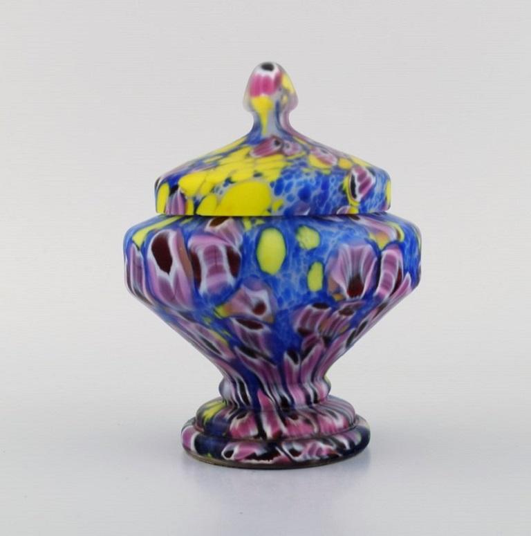 Art Deco lidded jar in polychrome mouth-blown art glass on a metal base. 
Italian style, 1930s / 40s.
Measures: 15 x 12 cm.
In excellent condition. Small hairline crack from production.