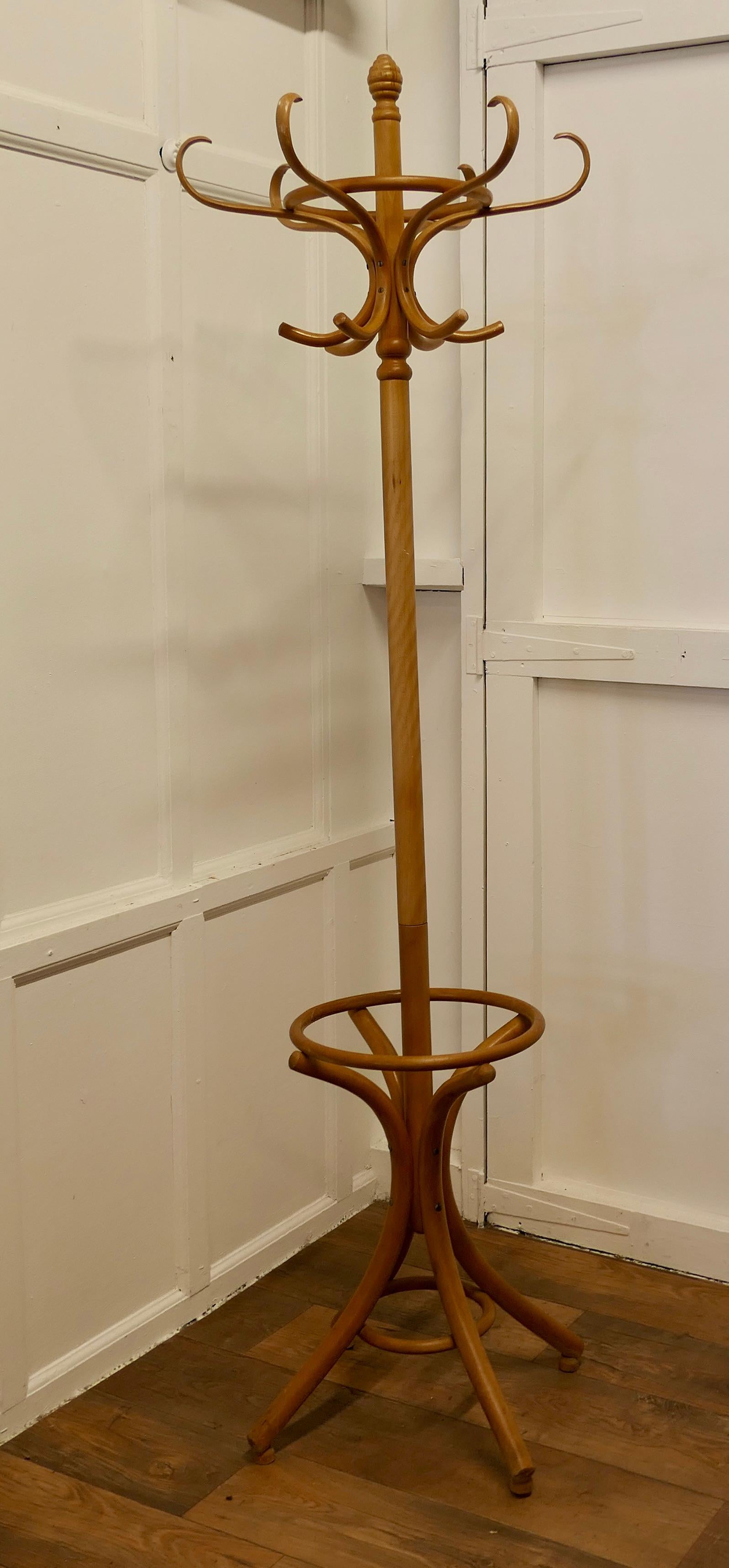 Art Deco Light Coloured Bent Wood Hall Stand

This is a very attractive piece it is a Round Hat & Coat Hall Stand, the stand has 6 Large Curved Bentwood Hat & Coat Hooks at the top and 4 large scrolling Legs forming the umbrella receptacle at the