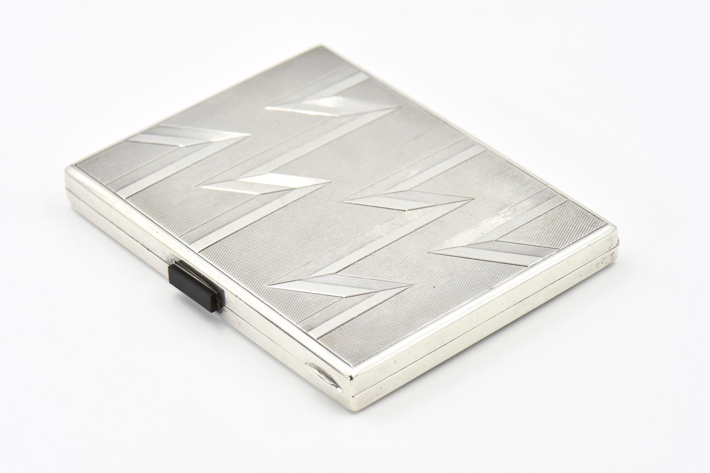 Stunning Art Deco cigarette case featuring a geometric lightning design on an engine turned 900 silver case. To open the case you push down on the onyx bar. It is marked 900 silver and has another mark that I can not read. It might be Austrian or