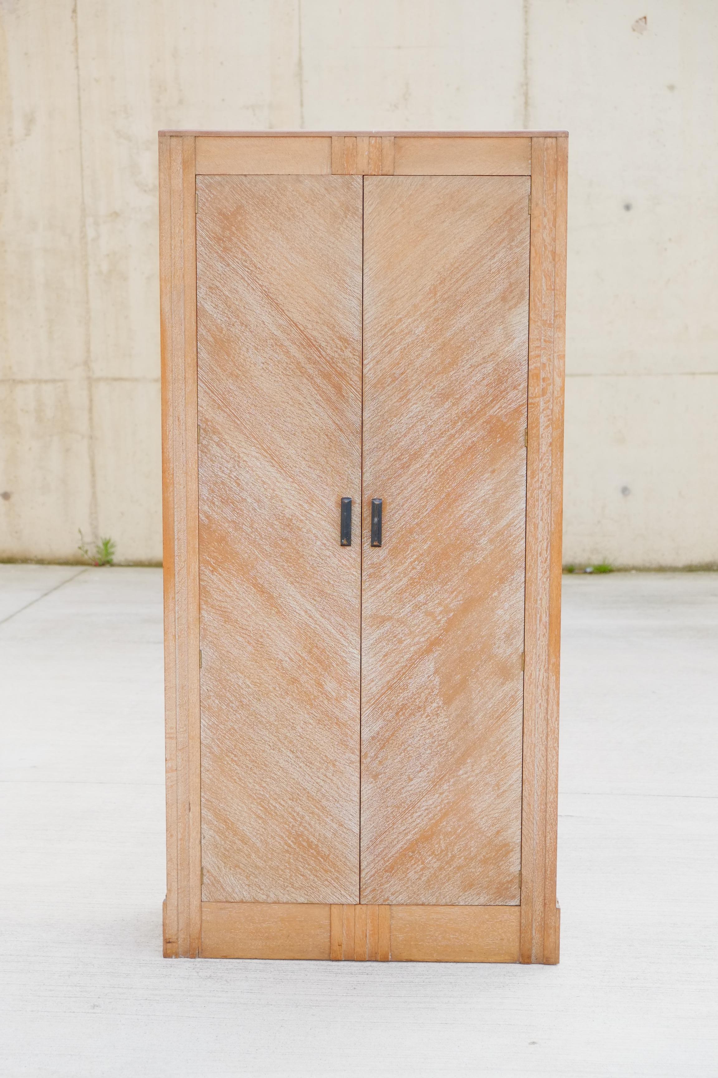 Stunning Art Deco wardrobe by English cabinet makers called; Hypnos. The wardrobe is made of solid oak with a lime wax finish. The Oak doors are stunning with a diagonal design. Subtle Art Deco decoration throughout. Beautiful colour and patina.