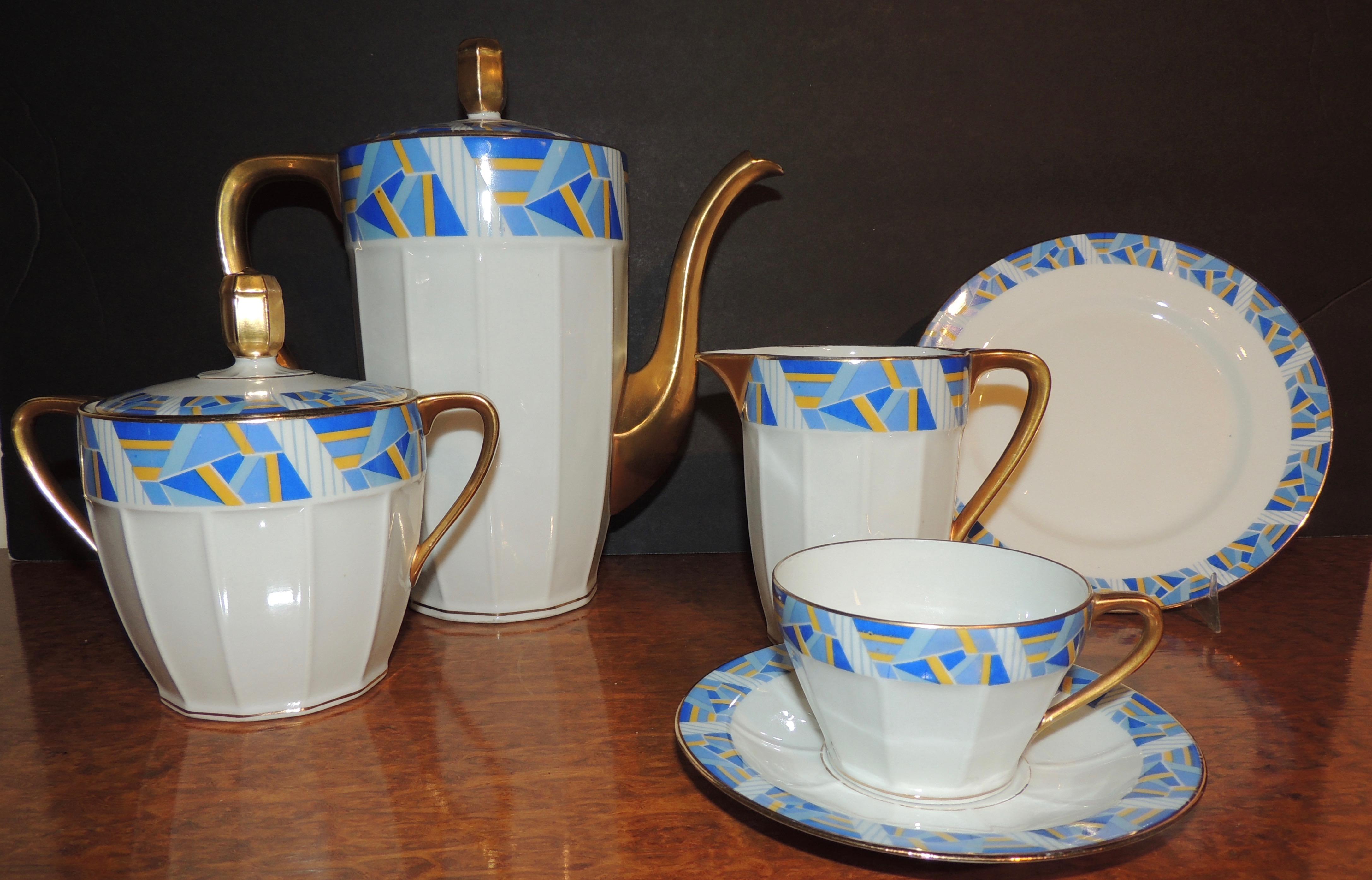 An Art Deco embellished china Dessert Set for Coffee or Tea from the company Vielle Abbaye in Limoges France.   This set is impeccable and includes a large coffee or teapot, creamer, sugar, twelve cups and saucers, ten dessert plates and extra small