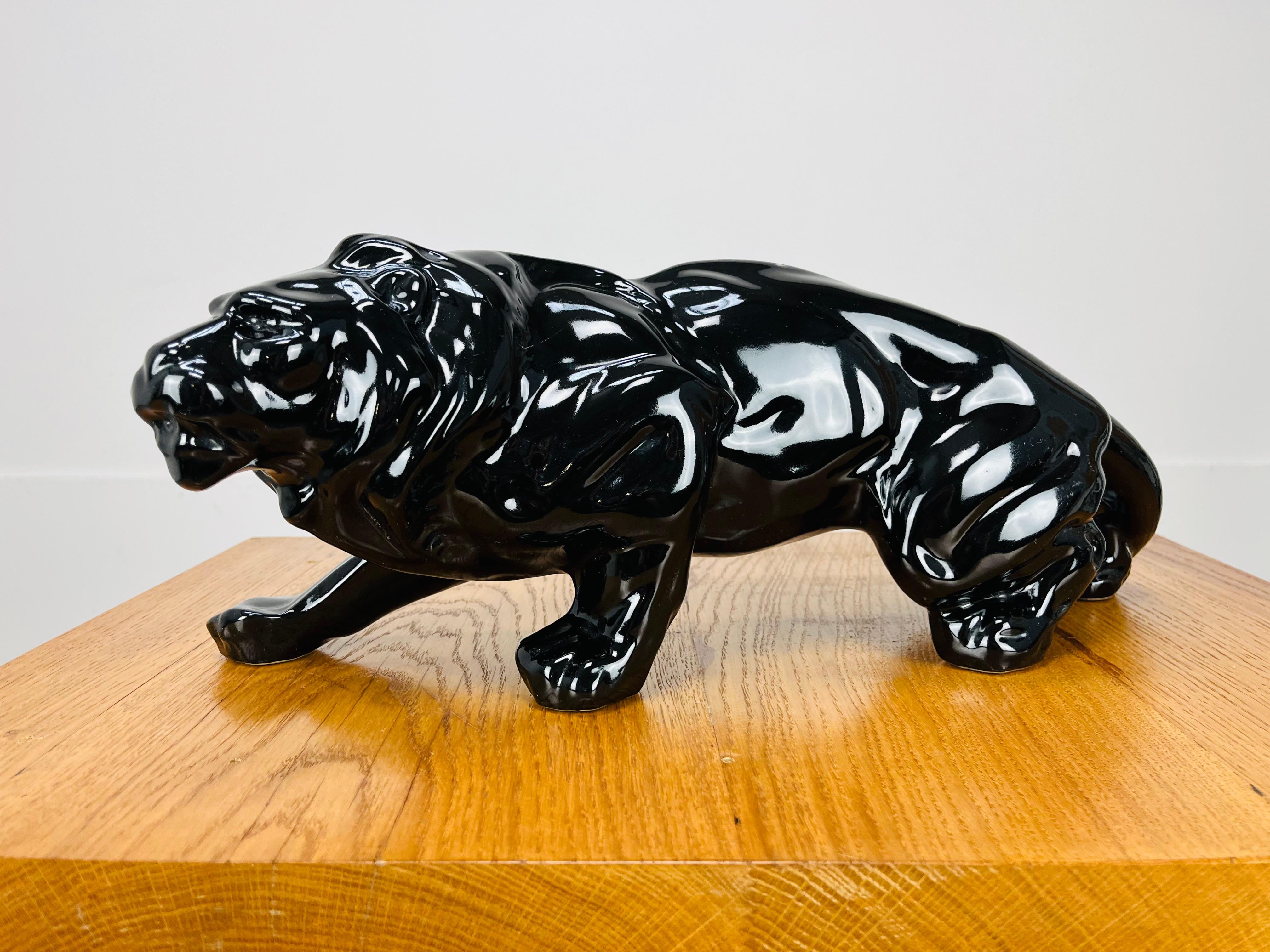 French Art Deco ceramic lion sculpture, 1930's. Black glaze.