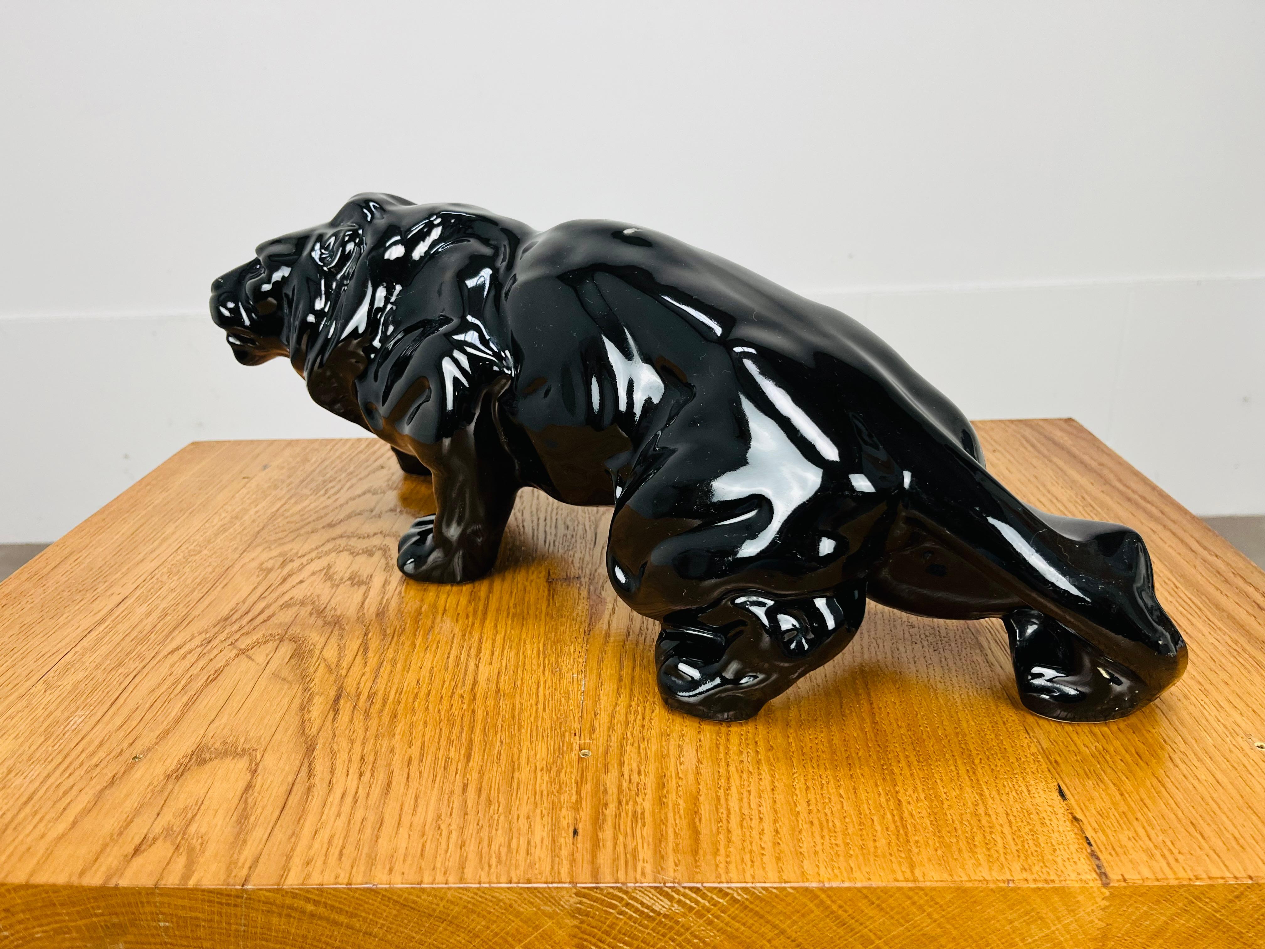 French Art Deco Lion sculpture, black ceramic, 1930's, in the style of Saint-Clément For Sale