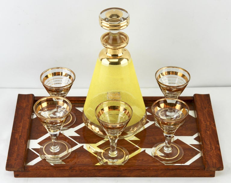 Glass factory de Rupel, boom, Belgium, with the label. 
Gold Decoration
Set with a decanter and 5 matching glasses and serving tray.

Dimensions: Decanter
Height 22 cm 8.66 inch
Width 11 cm 4.33 inch.

Dimensions: liqueur glass
Height 9.5