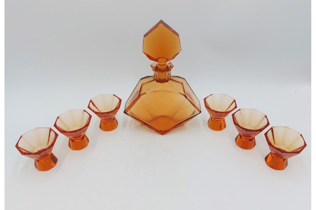 Art Deco liqueur set - decanter with six amber glasses.

The set was made in the Czech Republic in the 1930s.

The condition is very good, the only slight damage to one glass is visible in the last photo

Carafe: height 24cm, width 16cm, depth