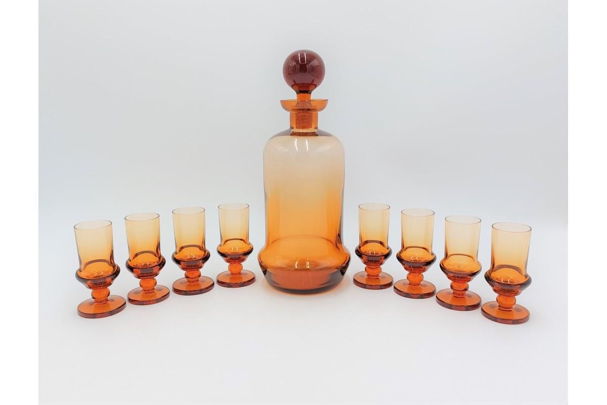 Art Deco liqueur set - a decanter with eight glasses made of amber glass

The set was made in the Czech Republic in the 1930s.

Very good condition, no damage

decanter height 26cm, diameter 9.5cm

glass height 10cm, diameter 4.5cm.
