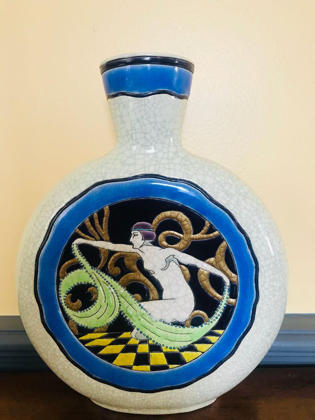 Rare and beautiful longwy Art Deco vase made in France in the 1920s. White craqueling glazed background with bright colorful image of nude female in flapper fashion. Vase is in excellent condition without cracks, chips or repairs. There is a glaze