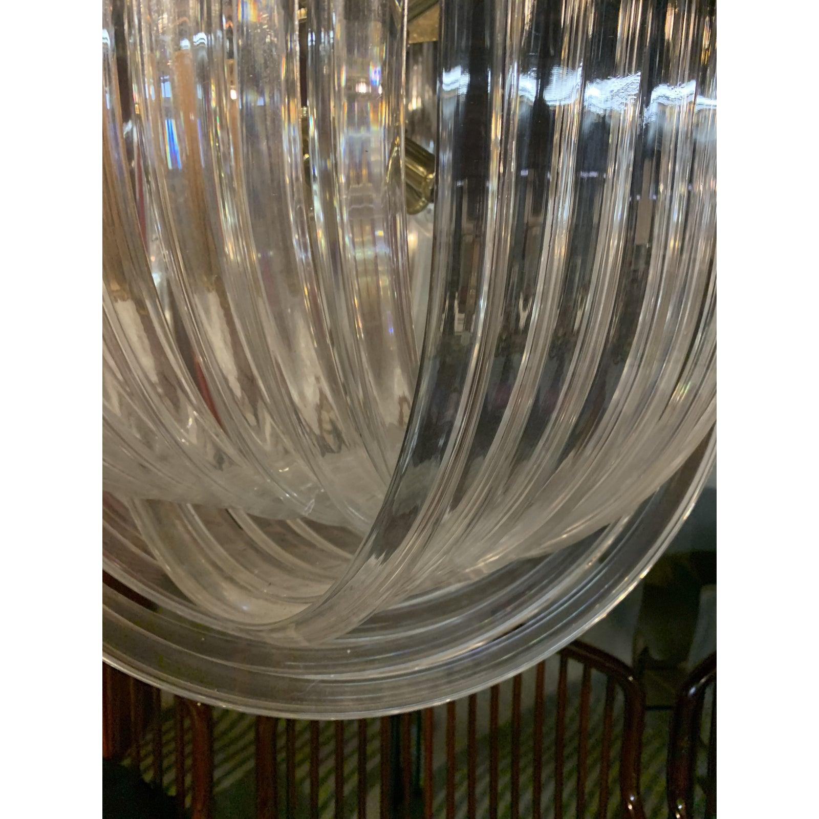 This handsome piece of lighting is comprised of hexagonal polished brass frame and chain, and a series of sculptural acrylic drops which let reflected light sparkle from the internal light fittings. 

It can work in modern & traditional interiors,