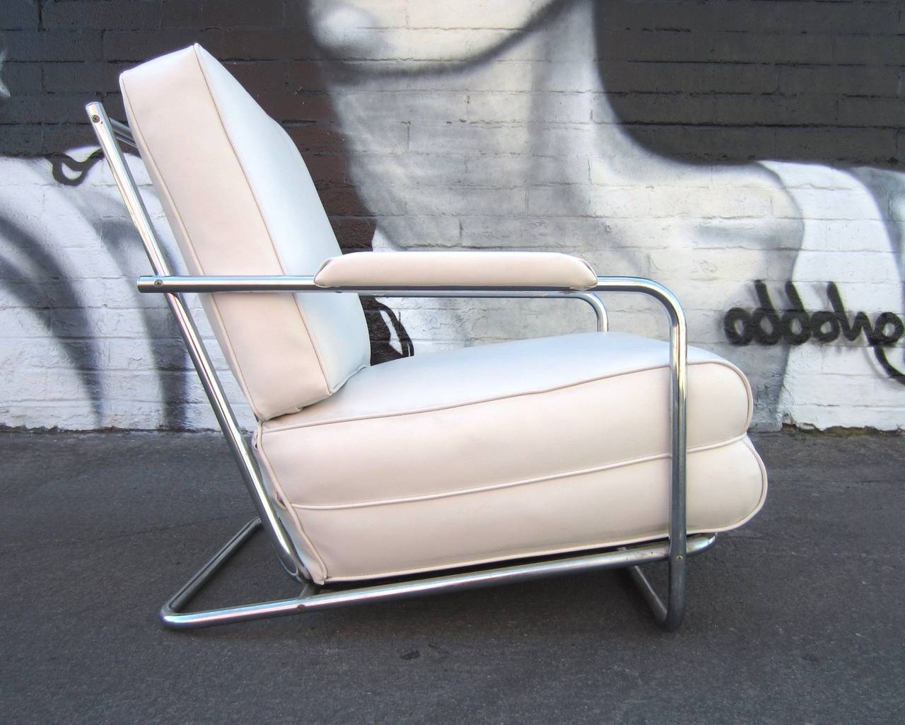 Gilbert Rohde design chrome tubing lounge chair by the Troy Sunshade Company, circa 1930s.
Newly upholstered in pure white vinyl over it's original cotton batting and horsehair cushion.
Very comfortable.
 