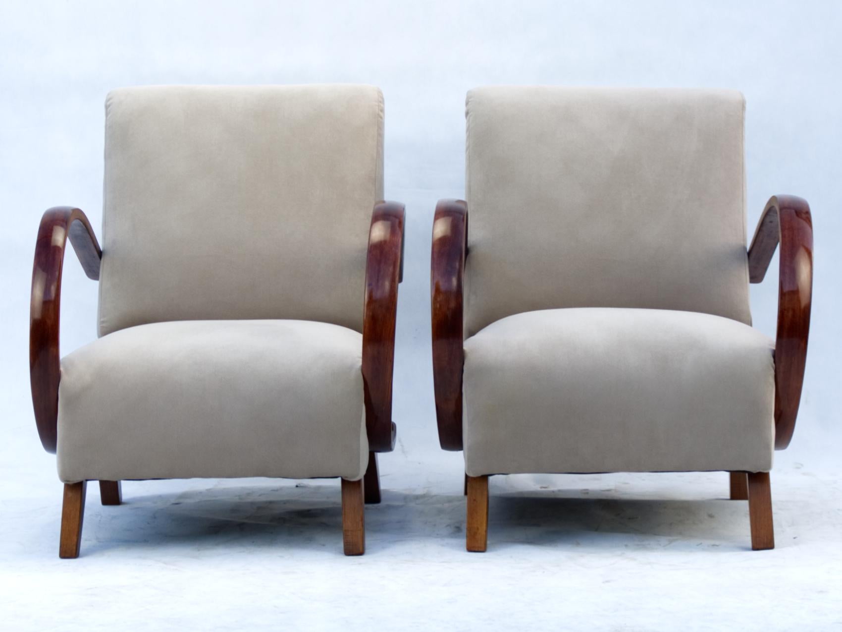 These lounge chairs, model C, were designed by Jindrich Halabala and produced in Czechoslovakia in the 1930s by UP Zavody Brno. The chairs have curved armrests and legs made from beech. 
New upholstery.