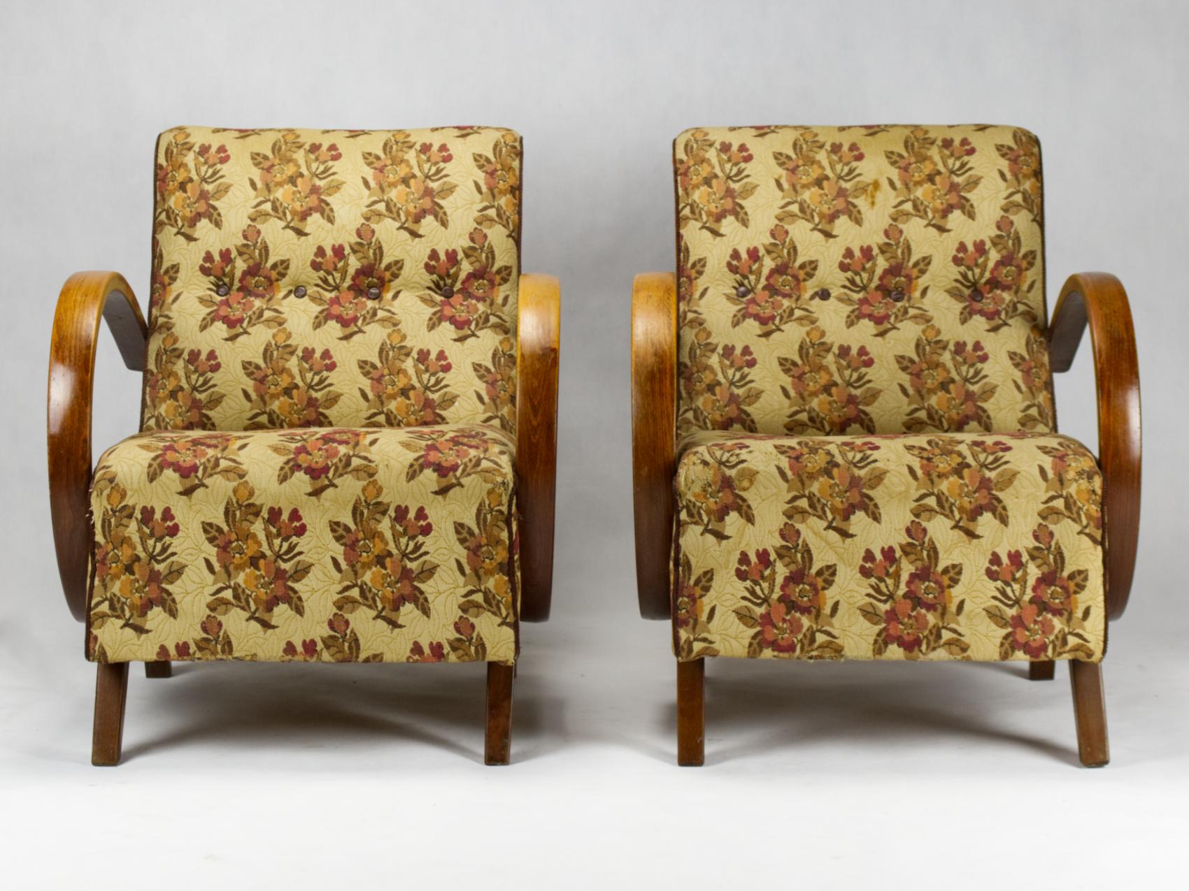 This lounge chairs, model C, were designed by Jindrich Halabala and produced in former Czechoslovakia in the 1930s by UP Zavody Brno. The chairs features curved armrests and legs made from stained beech and are upholstered in original fabric. The
