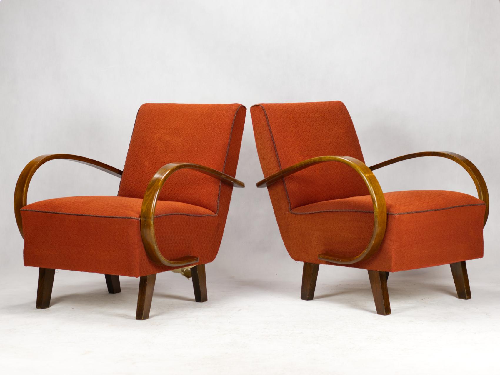 This lounge chairs, model C, were designed by Jindrich Halabala and produced in former Czechoslovakia in the 1930s by UP Zavody Brno. The chairs features curved armrests and legs made from stained beech and are upholstered in original fabric. The