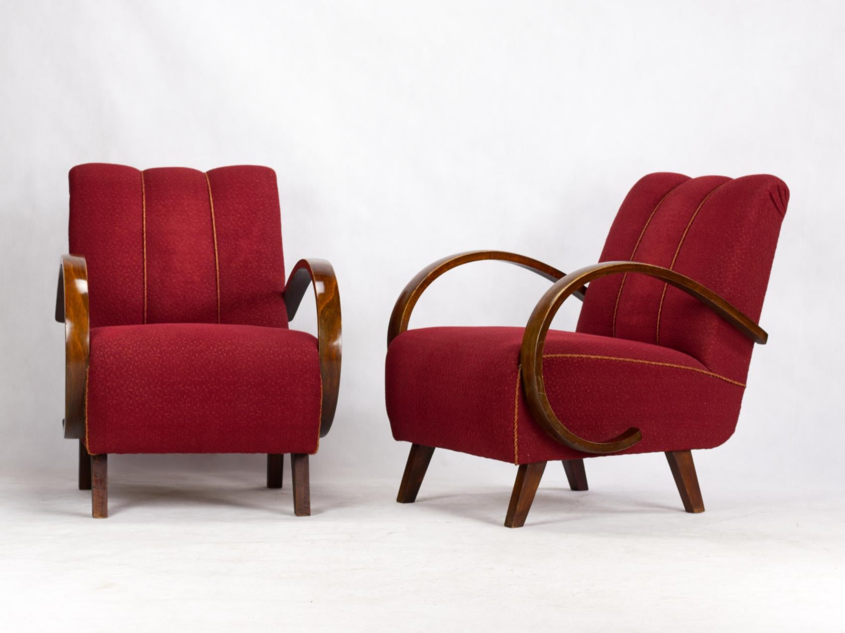 This lounge chairs, model C, were designed by Jindrich Halabala and produced in former Czechoslovakia in the 1930s by UP Zavody Brno. The chairs features curved armrests and legs made from stained beech and are upholstered in original fabric. The