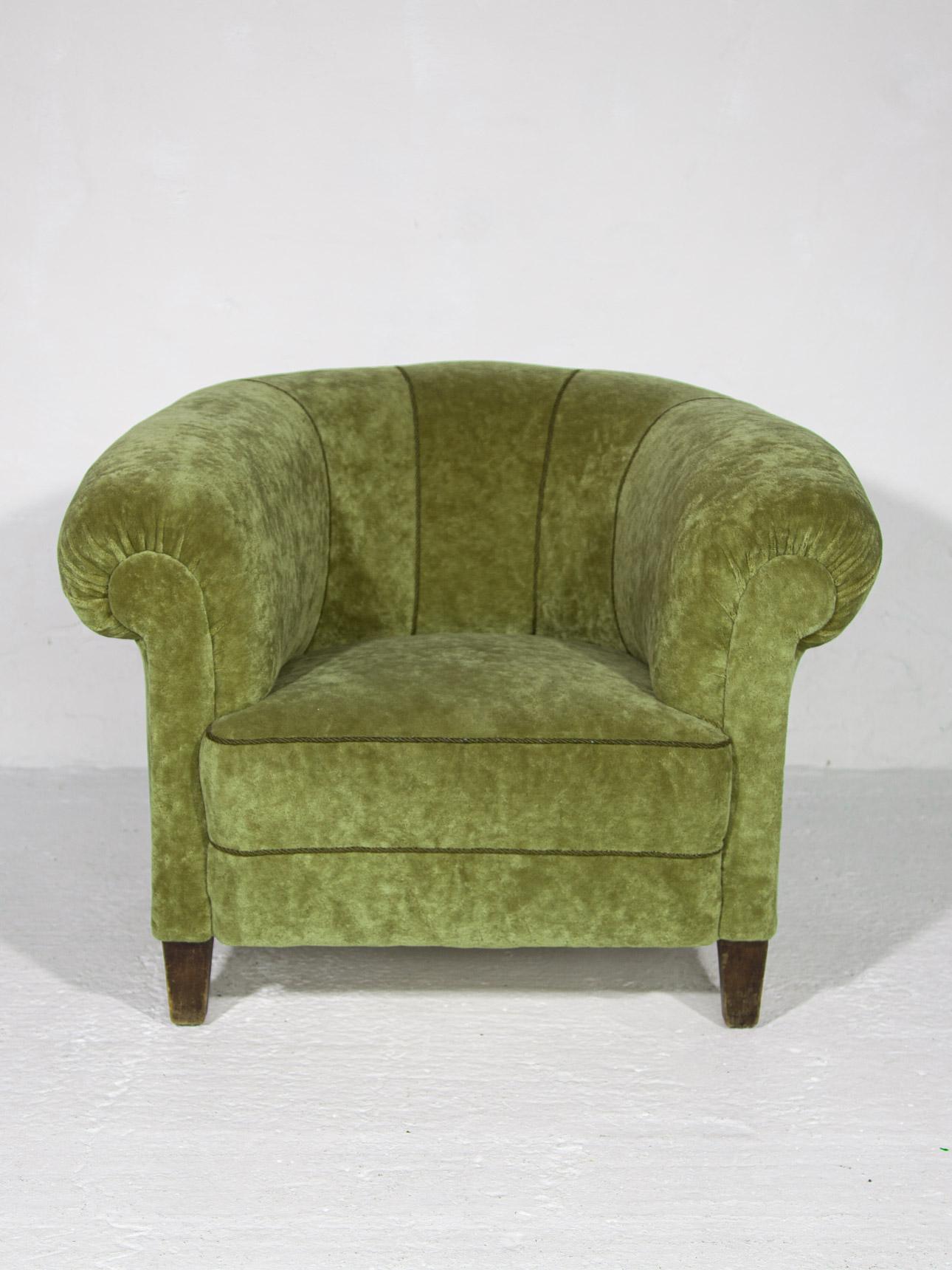 The soft and sensuous green olive velvet upholstery is in absolutely outstanding original condition. Rippled waterfall style pleated tailoring is punctuated by the spherical art deco accents on the arms. One does not have to compromise comfort for